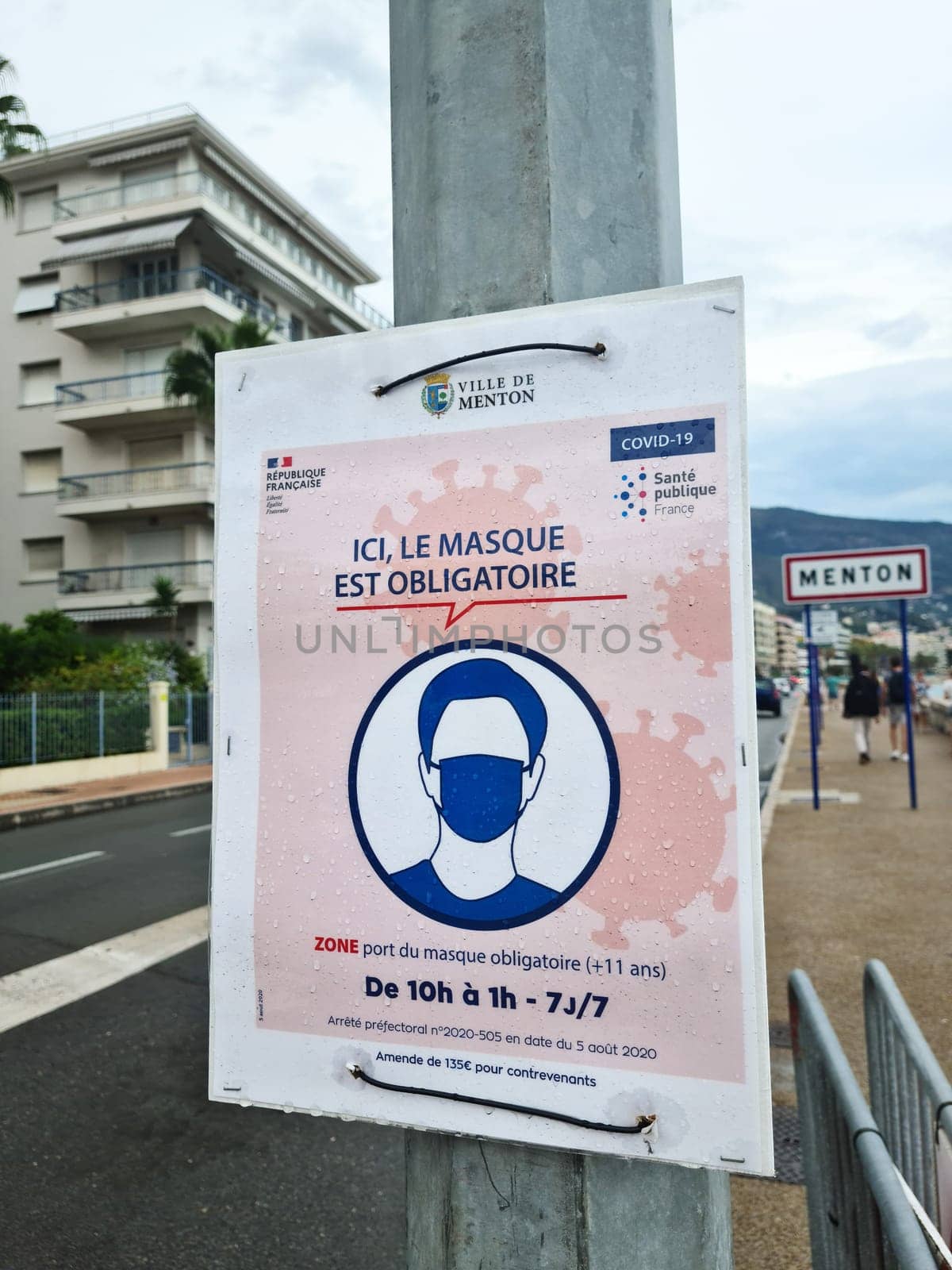 Menton, France - August 29, 2020: Coronavirus COVID-19 Face Mask Is Mandatory In The City Center Of Menton Says This Street Sign, France, Europe