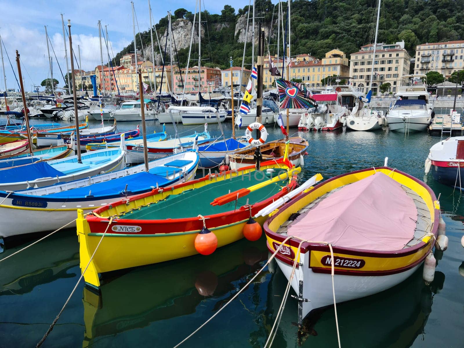 Nice, France - August 18, 2020: Small Colorful Wooden Fishing Boats Moored In The Old Port Of Nice, French Riviera, France, Europe