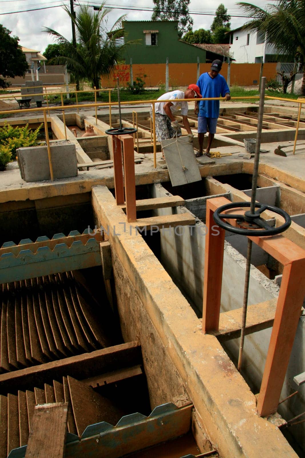 eunapolis, bahia / brazil - february 1, 2009: workers work to clean Embasa's water treatment plant in the city of Eunapolis.