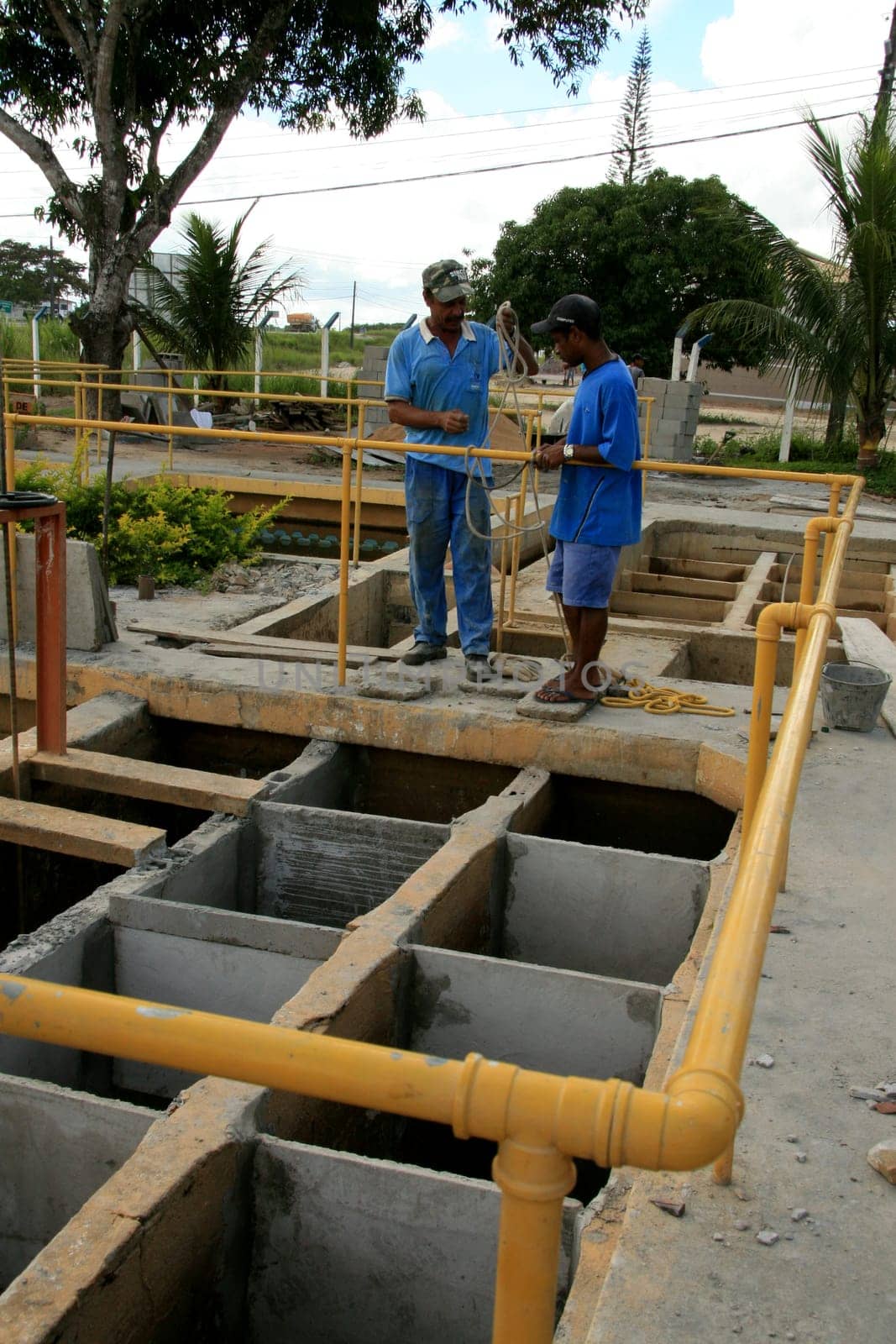 eunapolis, bahia / brazil - february 1, 2009: workers work to clean Embasa's water treatment plant in the city of Eunapolis.