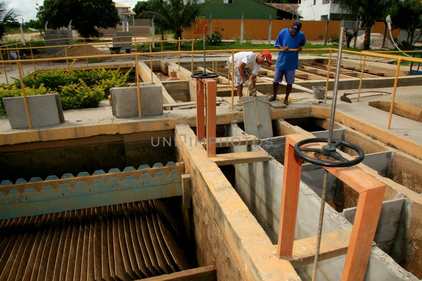 eunapolis, bahia / brazil - february 1, 2009: workers work to clean Embasa's water treatment plant in the city of Eunapolis.