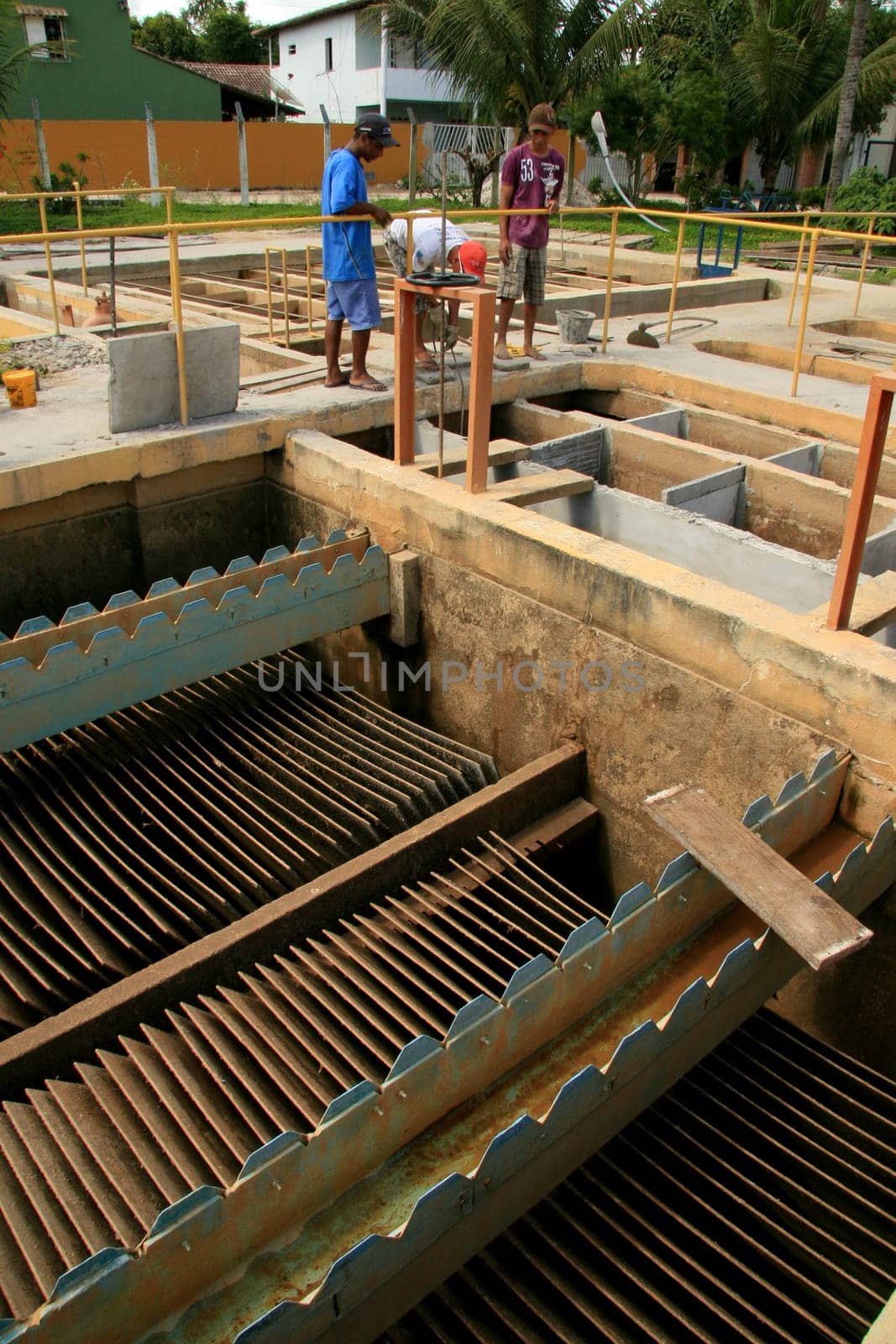 eunapolis, bahia / brazil - february 1, 2009: workers work to clean Embasa's water treatment plant in the city of Eunapolis.