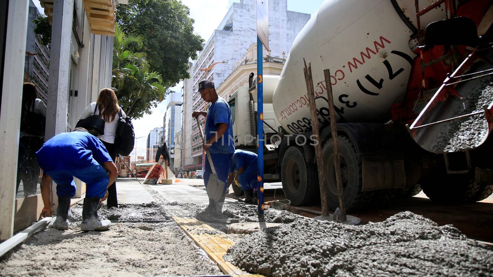 salvador, bahia / brazil - september 8, 2020: bricklayers work on the construction of a sidewalk in the neighborhood of Comercio in the city of Salvador.