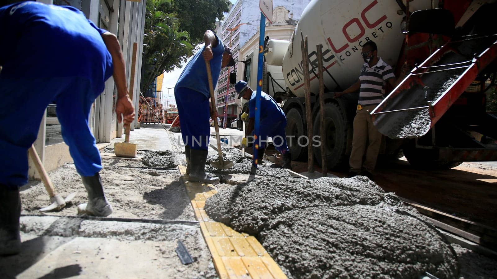 salvador, bahia / brazil - september 8, 2020: bricklayers work on the construction of a sidewalk in the neighborhood of Comercio in the city of Salvador.