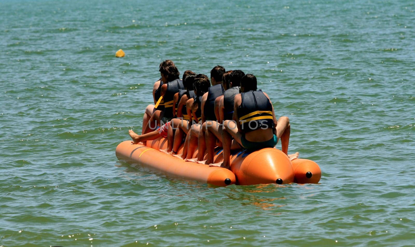 porto seguro, bahia / brazil - january 8, 2009: People are seen aboard a vessel known as a banana boat on the beach in the city of Porto Seguro.