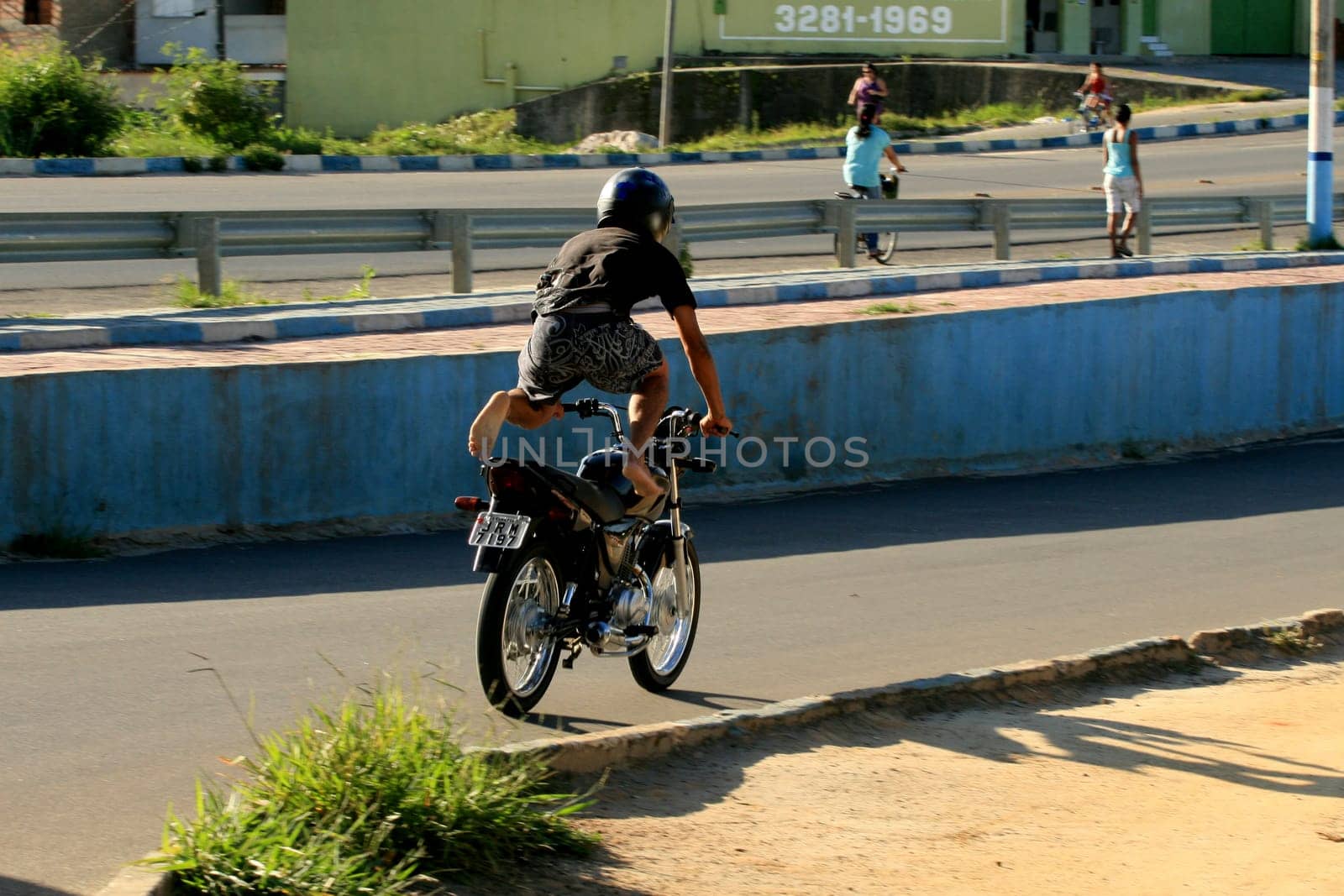 eunapolis, bahia / brazil - january 15, 2009: motocilcista is seen standing while the vehicle is traveling on the BR 101 highway in the city of Eunapolis.