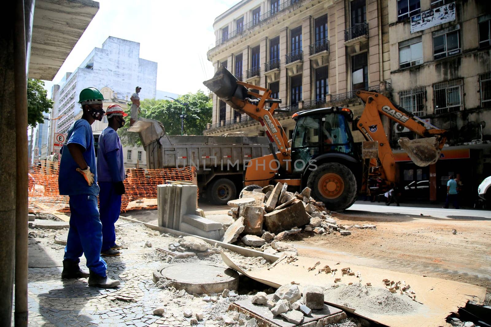 salvador, bahia / brazil - september 8, 2020: backhoe trablah collecting rubble from sidewalk contraction in the neighborhood of Comercio in the city of Salvador.