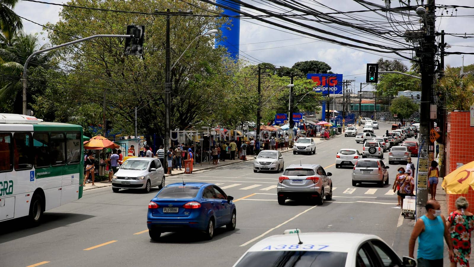 salvador, bahia / brazil - september 11, 2020: people and vehicles are seen on a street in the neighborhood of Cabula in the city of Salvador.