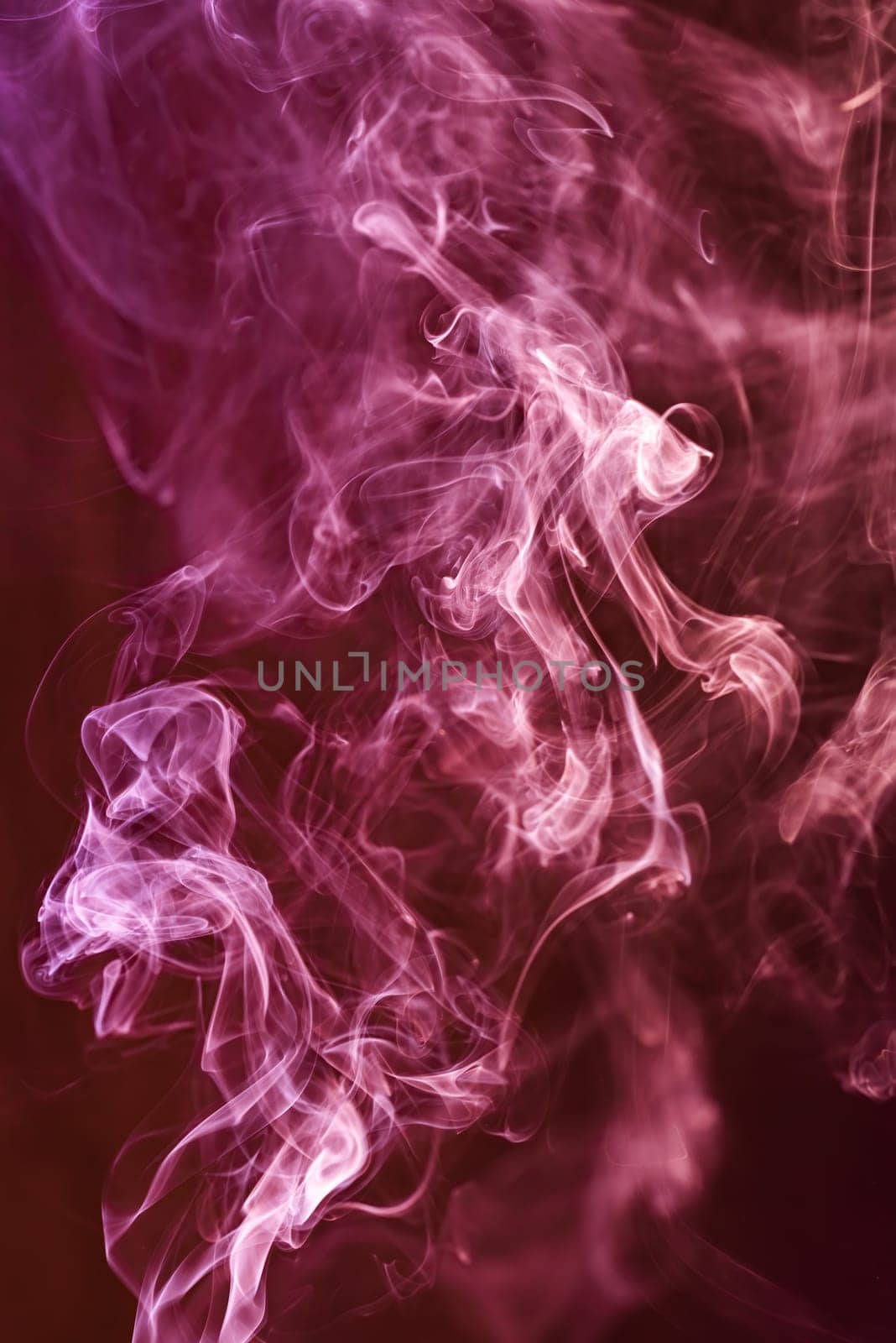 Red abstract shaped smoke against black background. Abstract background. Selective focus