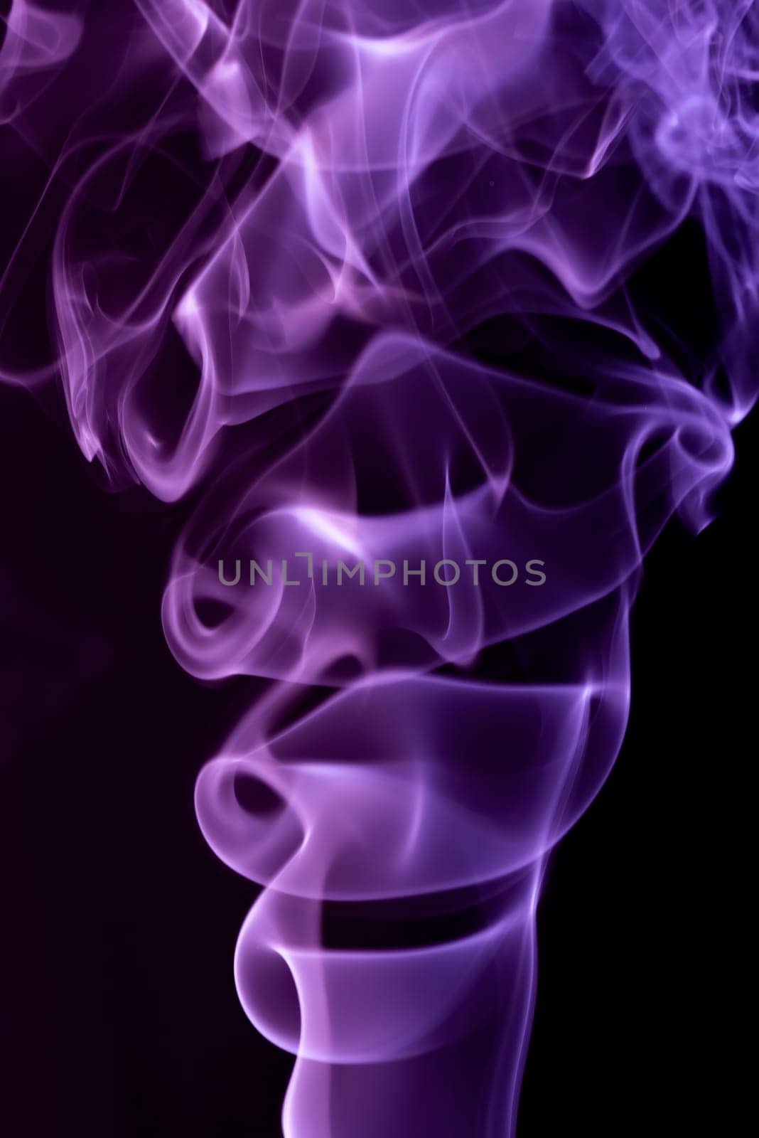 Violet abstract shaped smoke against black background. Abstract background. Selective focus