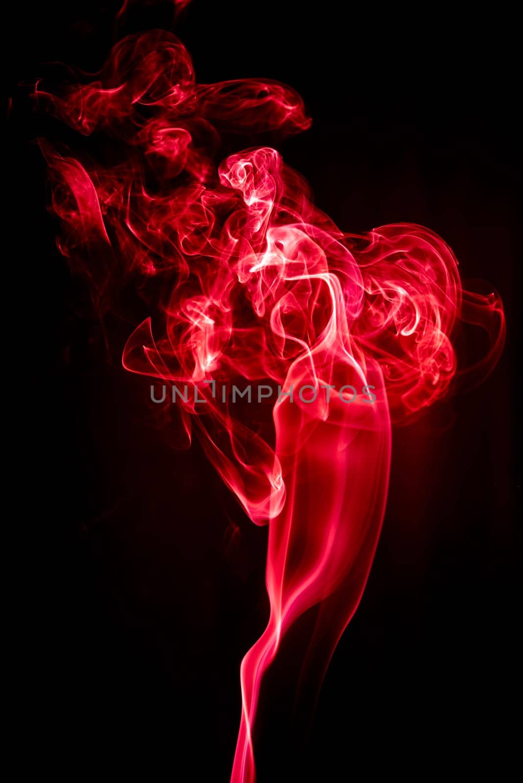 Red abstract shaped smoke against black background. Abstract background. Selective focus