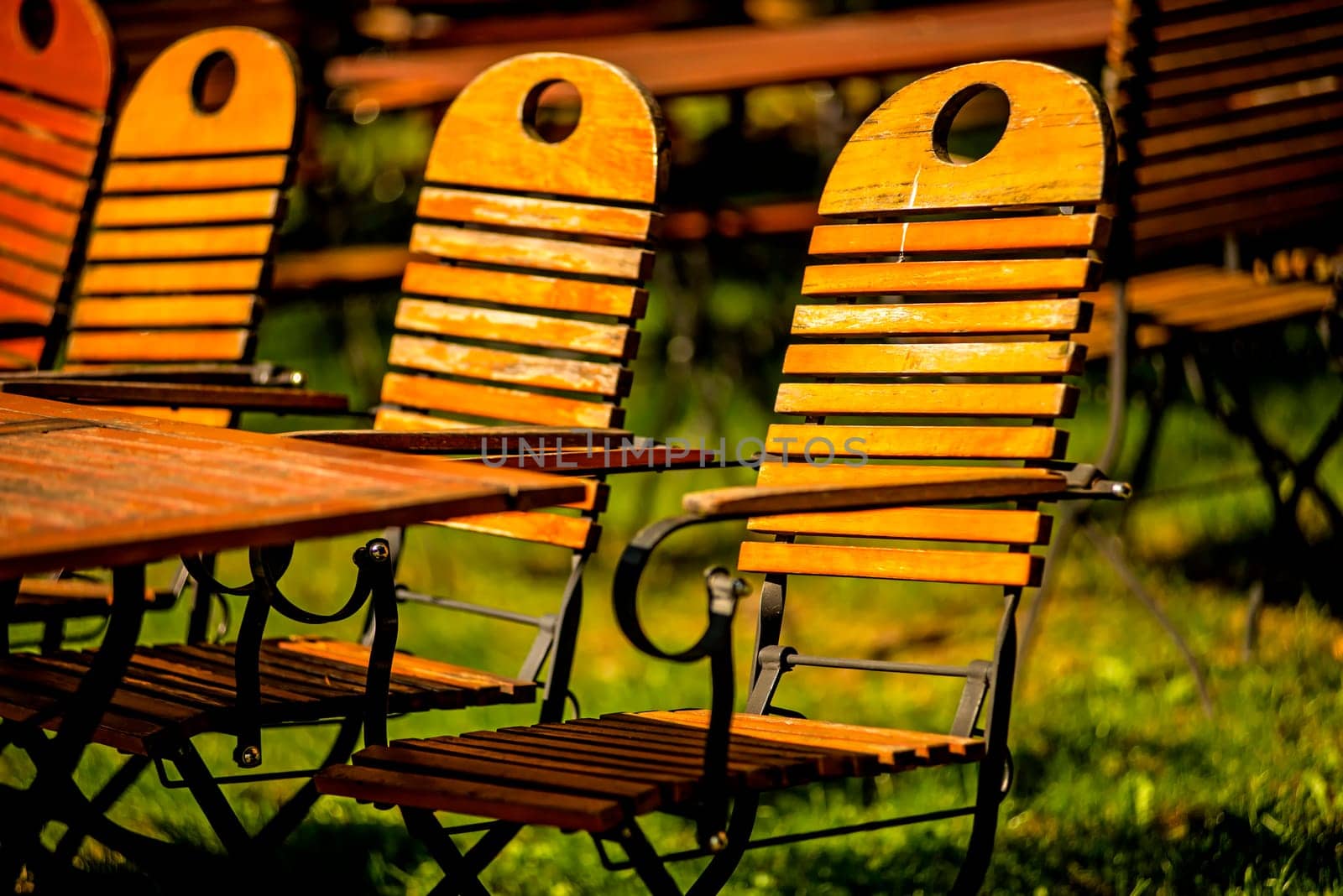 empty chairs and desks of a garden restaurant