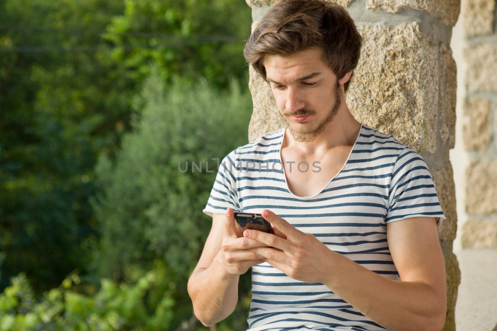 young casual man on the phone, outdoor