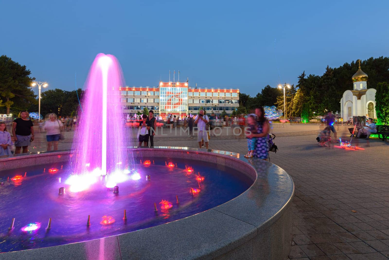 Anapa, Russia - July 17, 2020: View of the tourist-filled square in front of the administration of the city of the Anapa resort, on which there are fountains and a small chapel