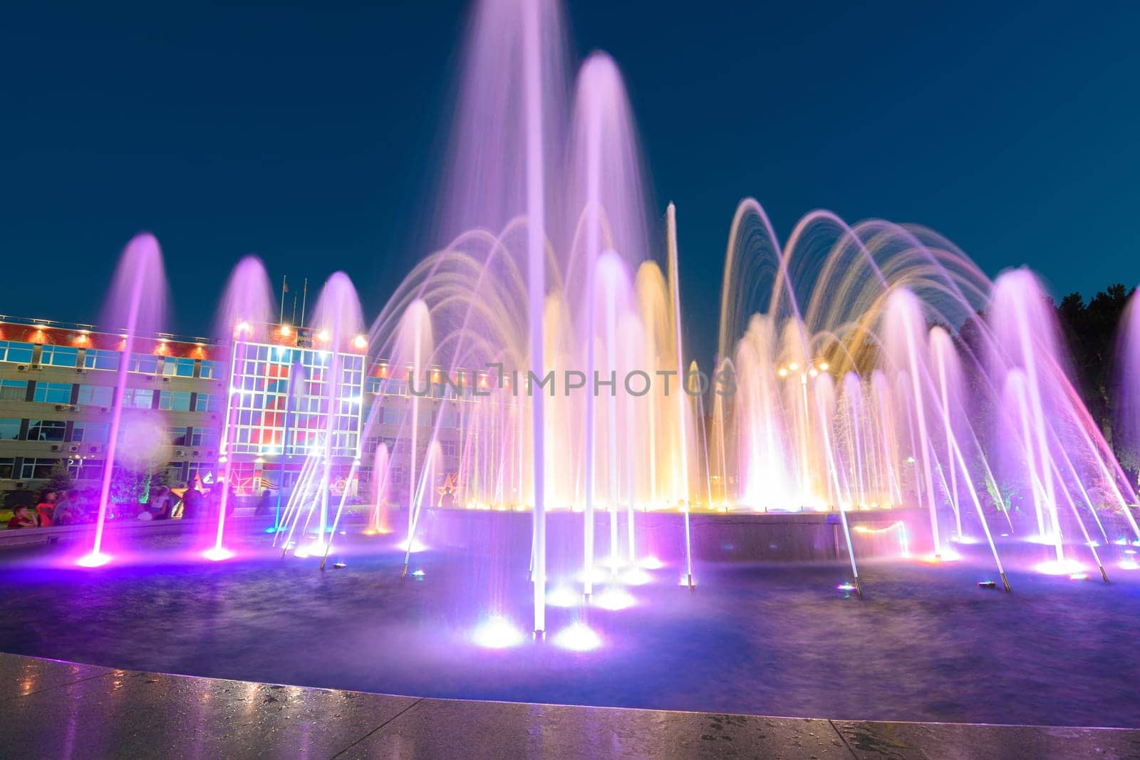 Anapa, Russia - July 17, 2020: View of a large beautiful multi-colored fountain in front of the city administration building of the Anapa resort