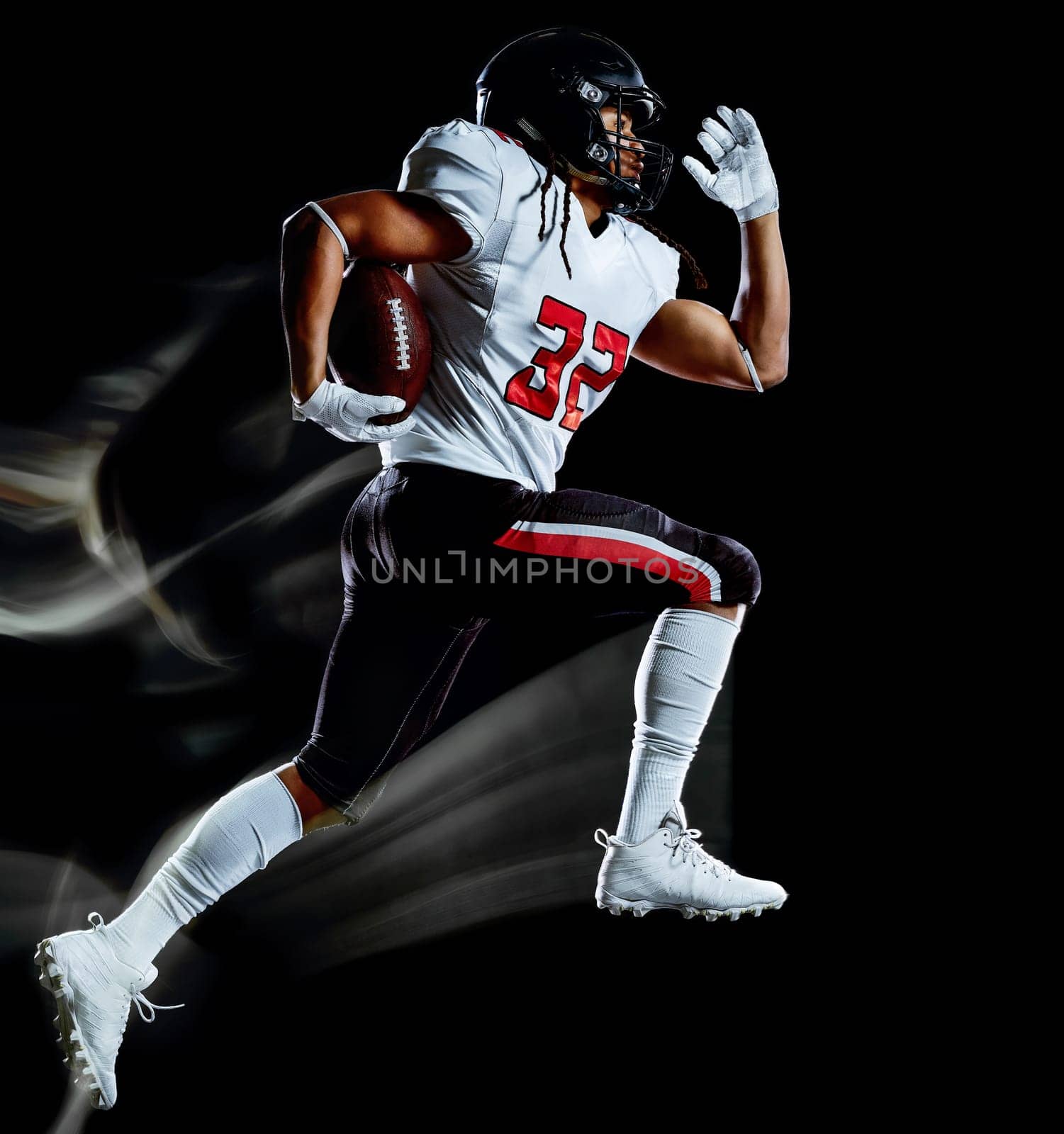 one african american football player man studio shot isolated on black background with light painting with blurred motion speed effect