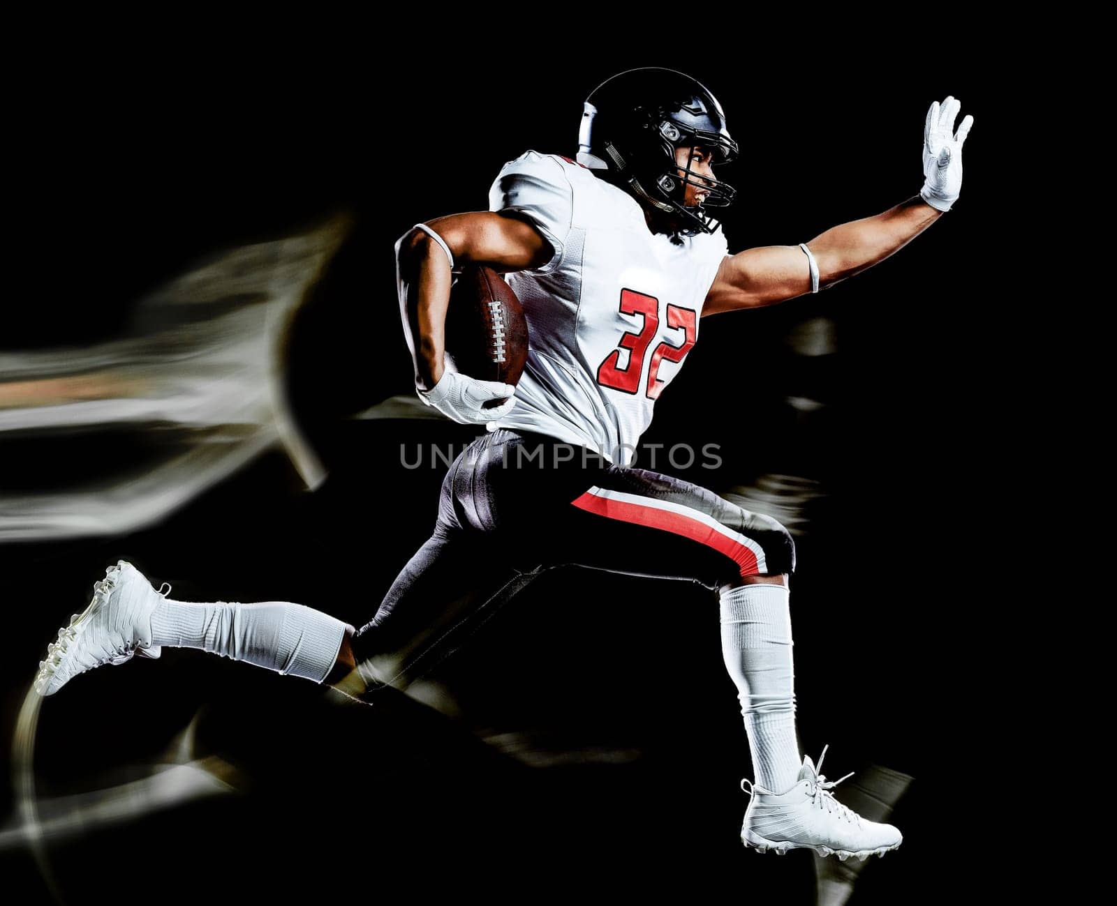 one african american football player man studio shot isolated on black background with light painting with blurred motion speed effect
