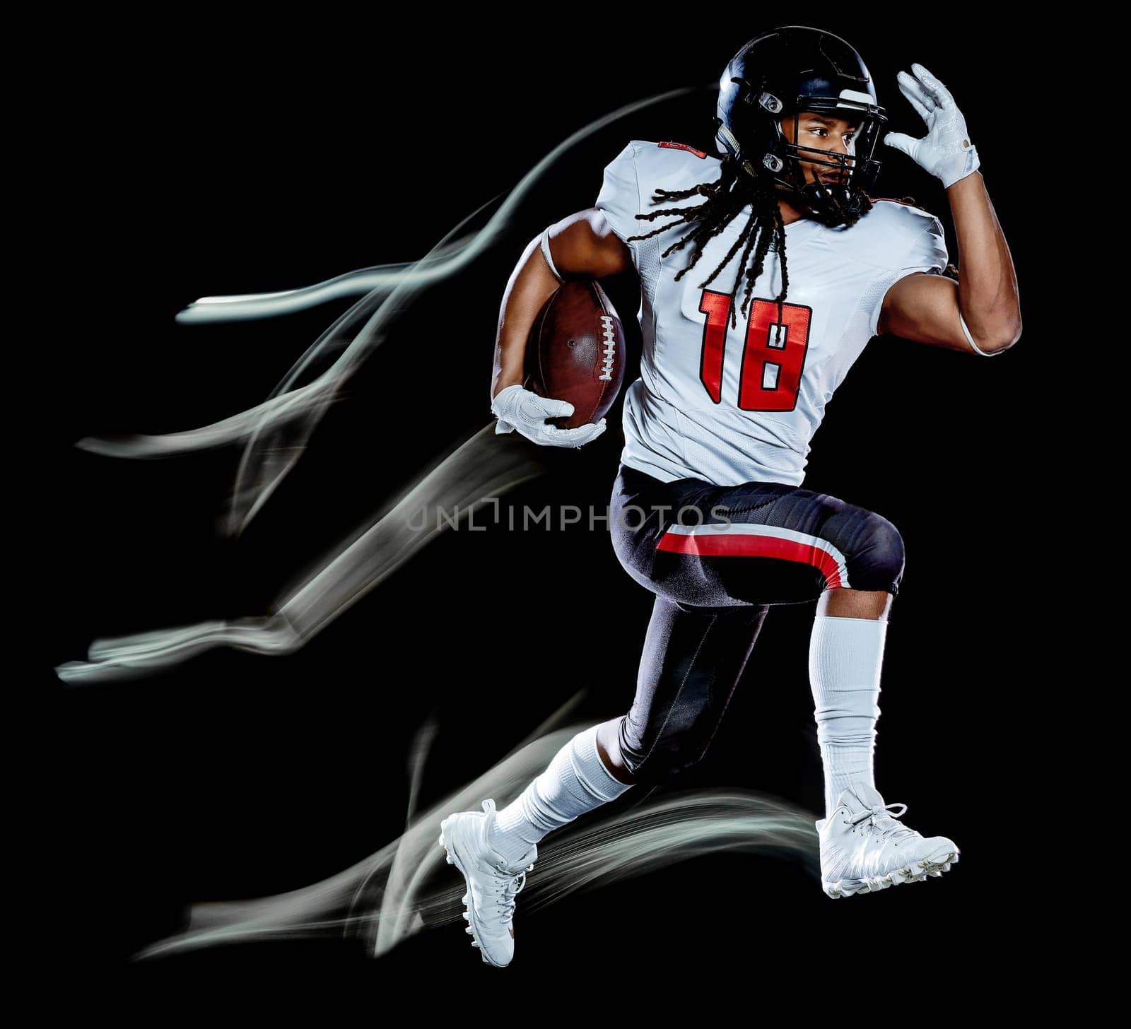 one african american football player man studio shot isolated on black background with light painting with blurred motion speed effect