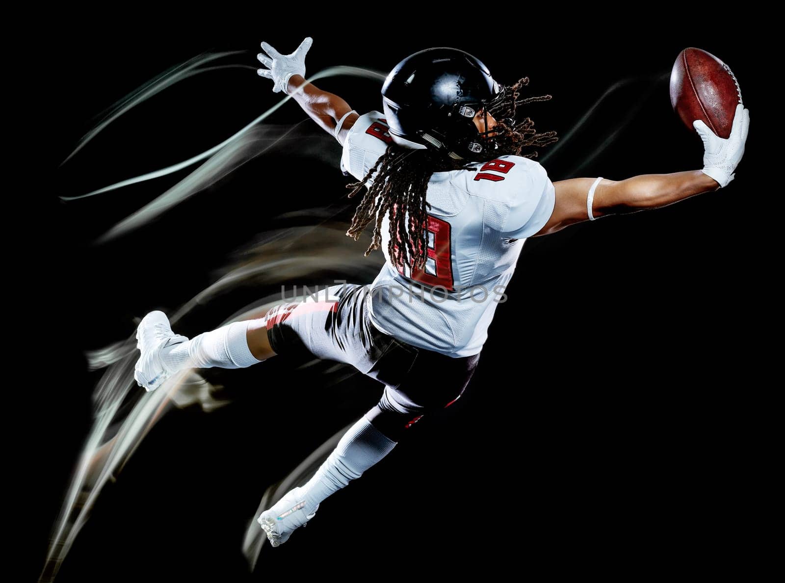 one african american football player man studio shot isolated on black background with light painting with blurred motion speed effect
