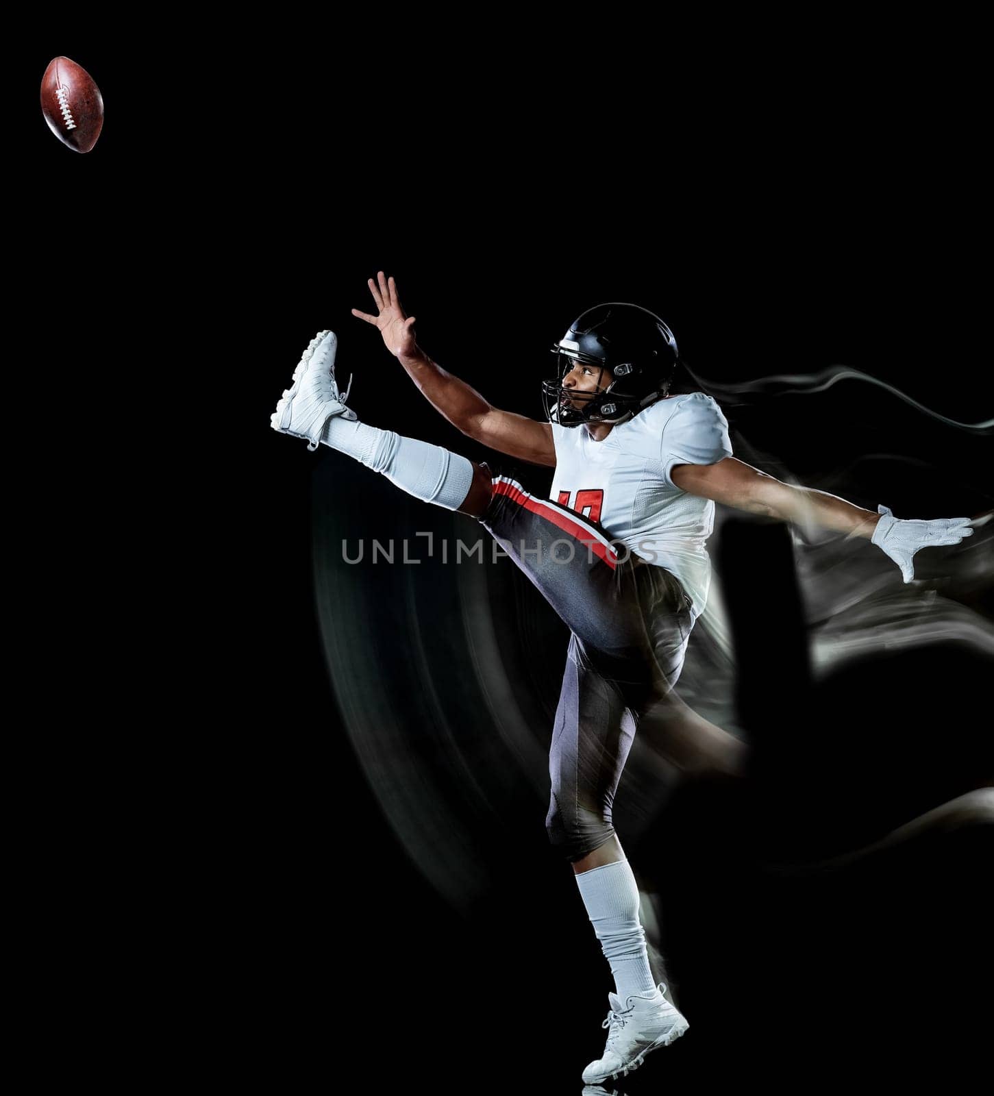 one african american football player man studio shot isolated on black background with light painting with blurred motion speed effect