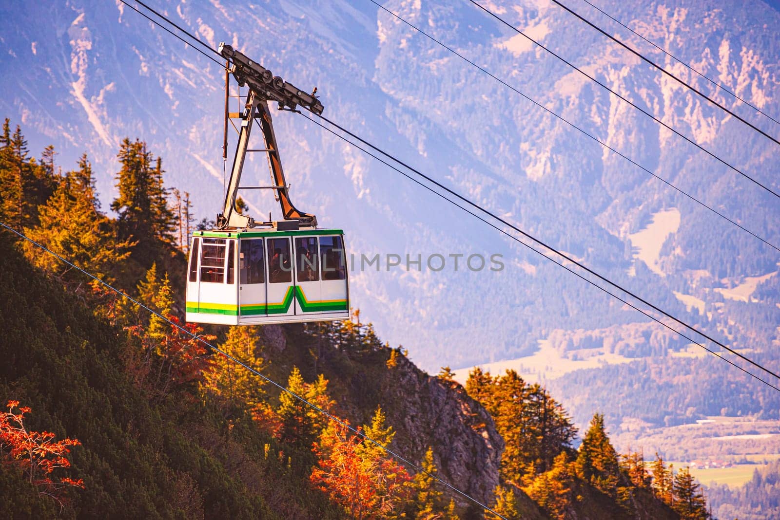 Tegelberg Cable Car in Bavaria, near Fussen, Germany, Europe. Mountain slope in foreground with trees and distant mountains in background