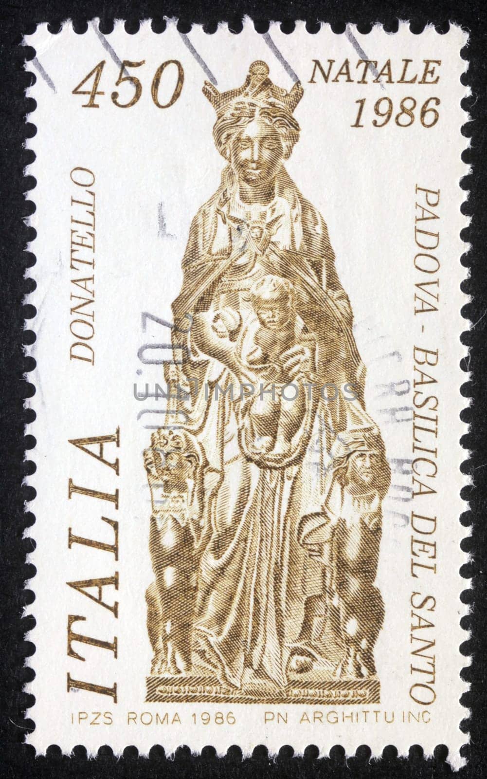 Christmas stamp printed in Italy shows sculpture by artist Donatelo -  Madonna with child, circa 1986