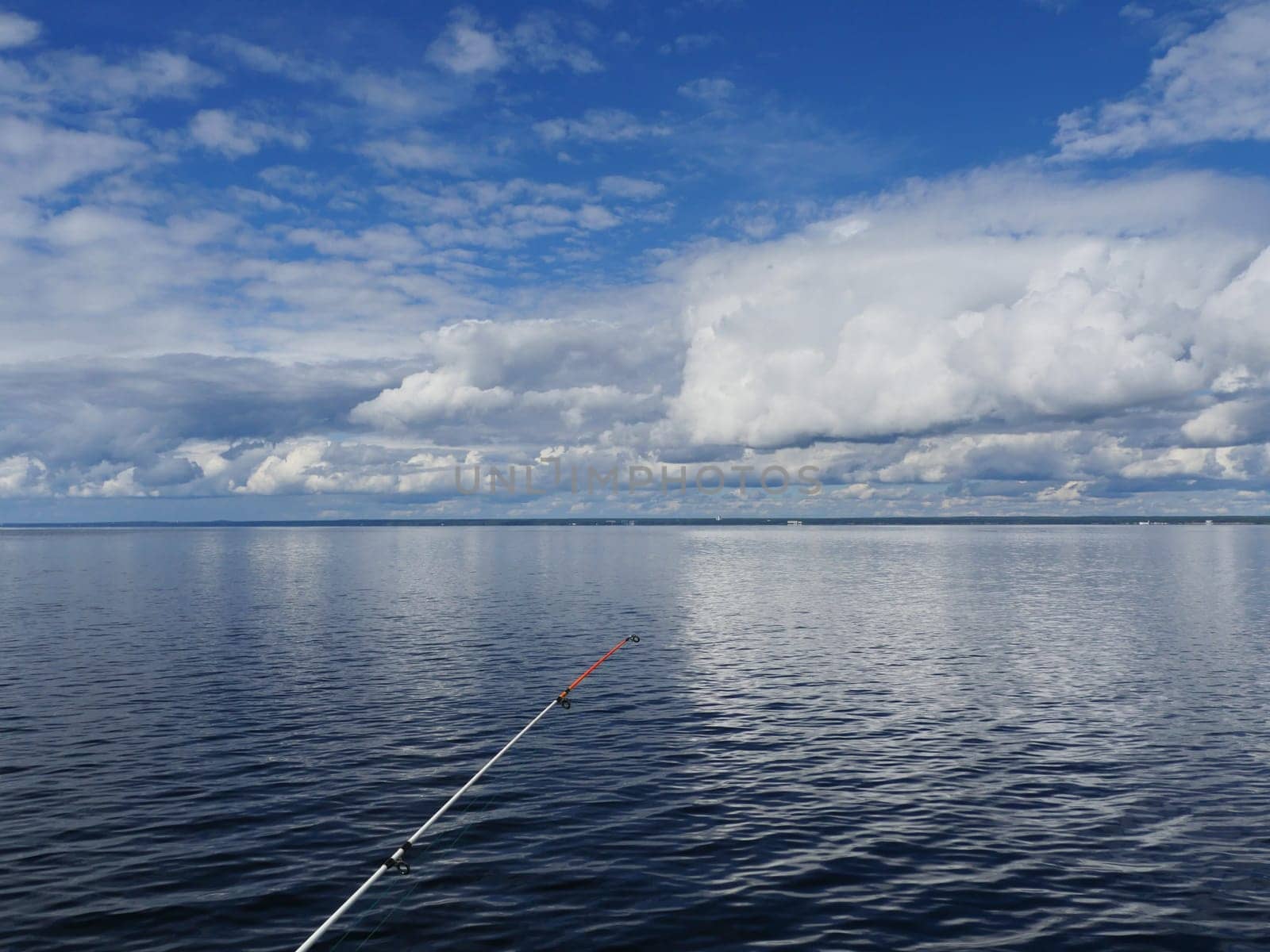 sea fishing, seascape cumulus clouds reflected in sea water