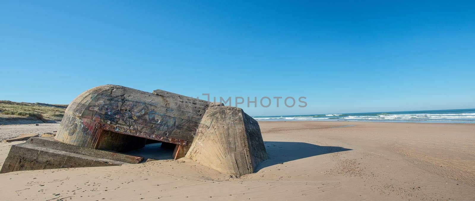 the ruins of german bunker in the beach of Normandy, France