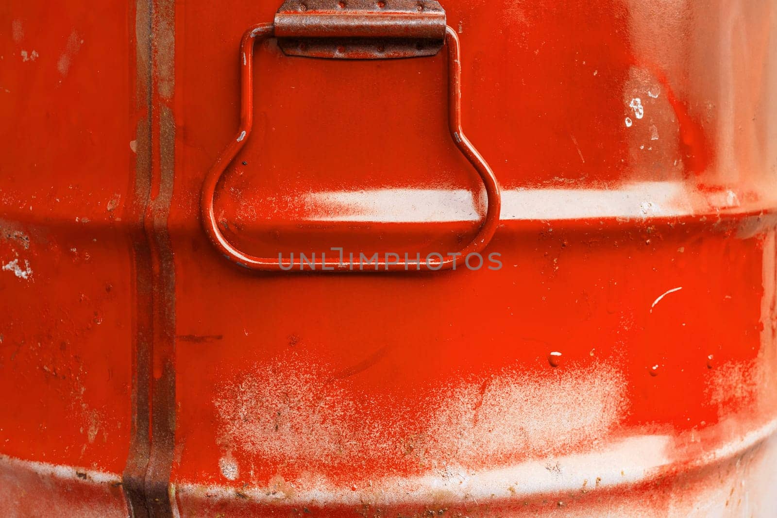Red color can. Metal can with red paint drips.
