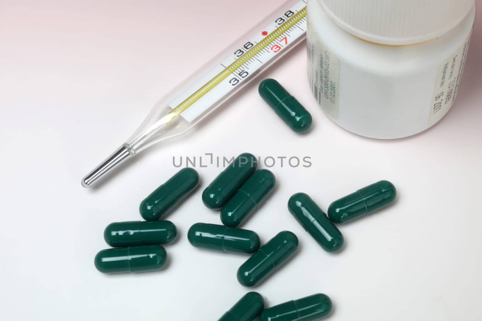 Close-up medical thermometer and pills