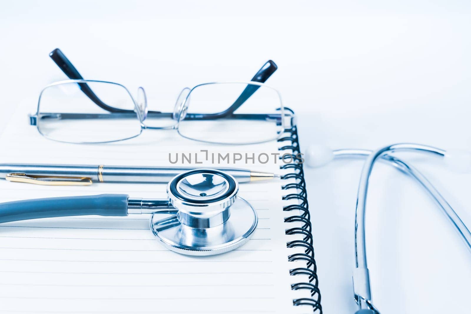 Close up Medical stethoscope with blank notepad as medical concept