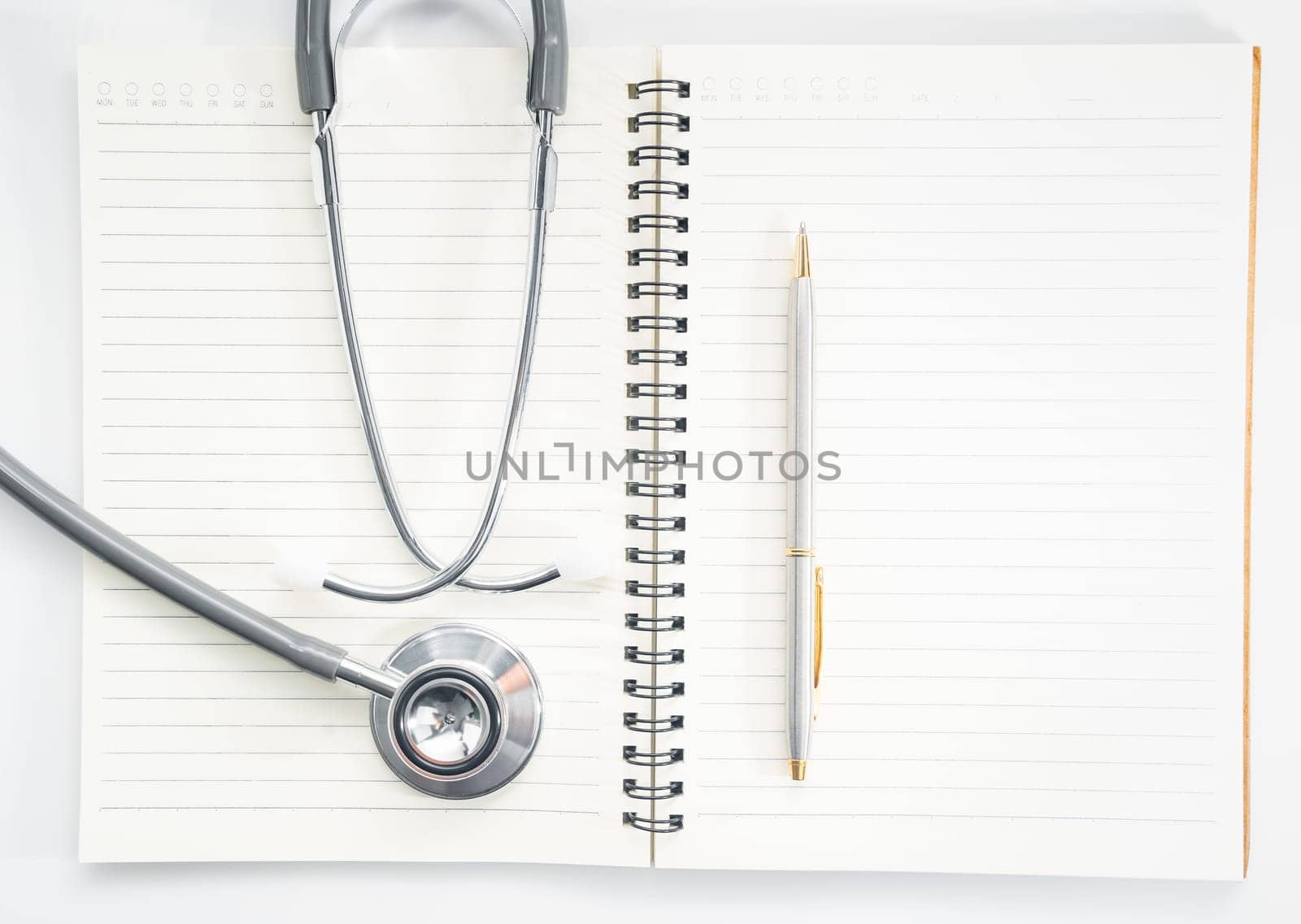 Close up stethoscope on blank notepad as medical concept