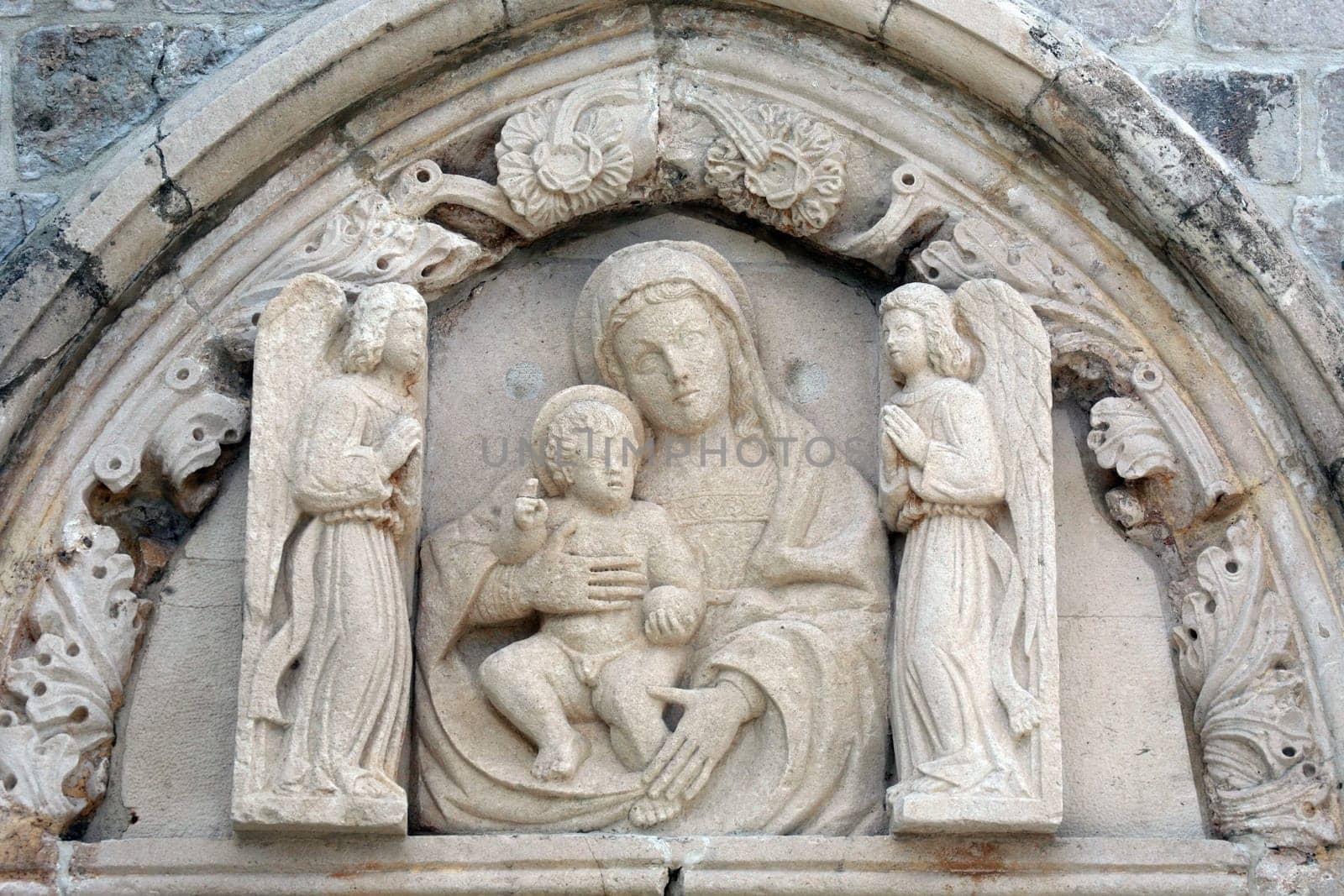Statue of the Virgin Mary with baby Jesus on the portal of the church of St. Mary of Mercy in Dubrovnik, Croatia