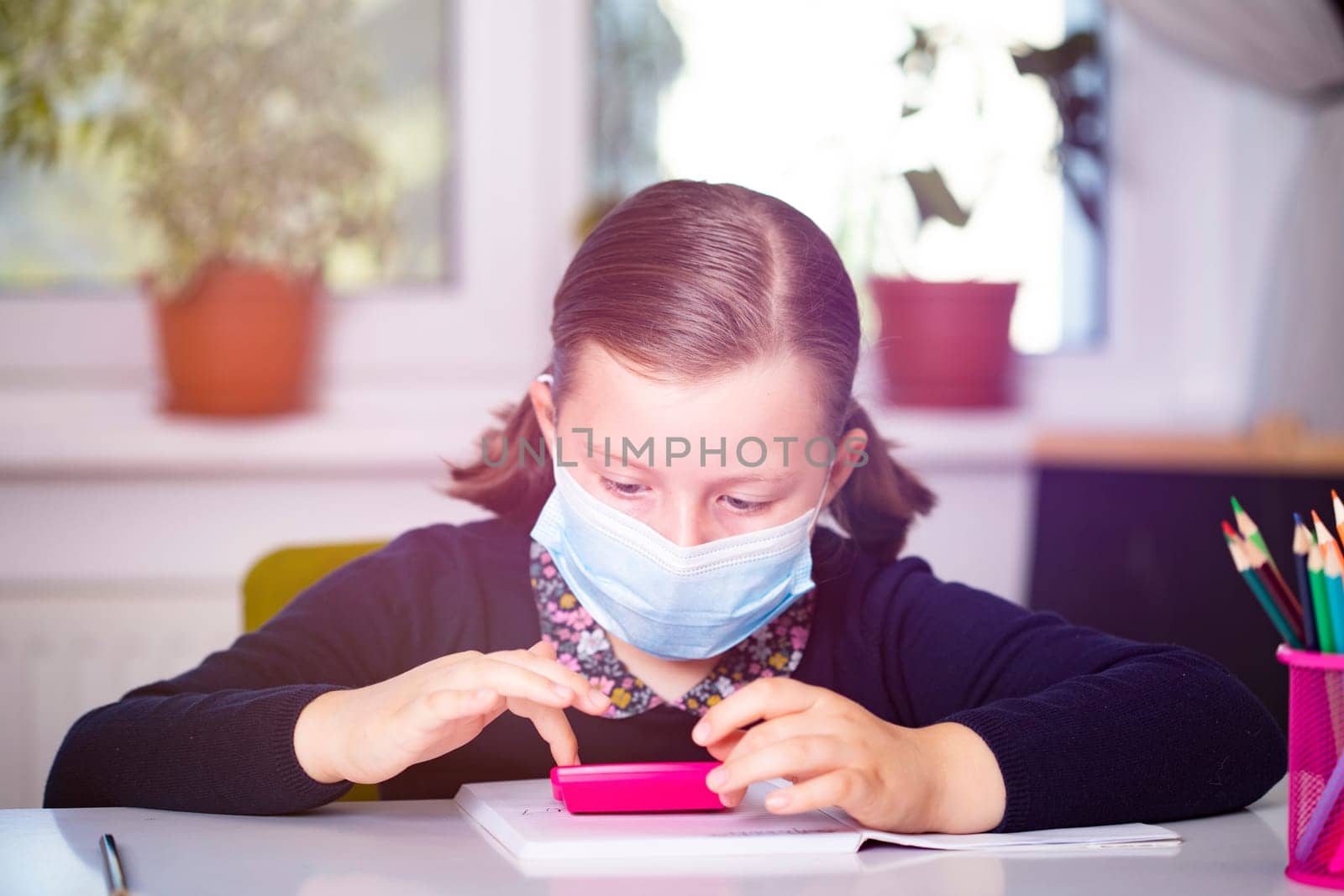 School child wearing mask for protection against coronavirus in school. Measures to prevent the spread of COVID-19 at schools during coronavirus pandemic.