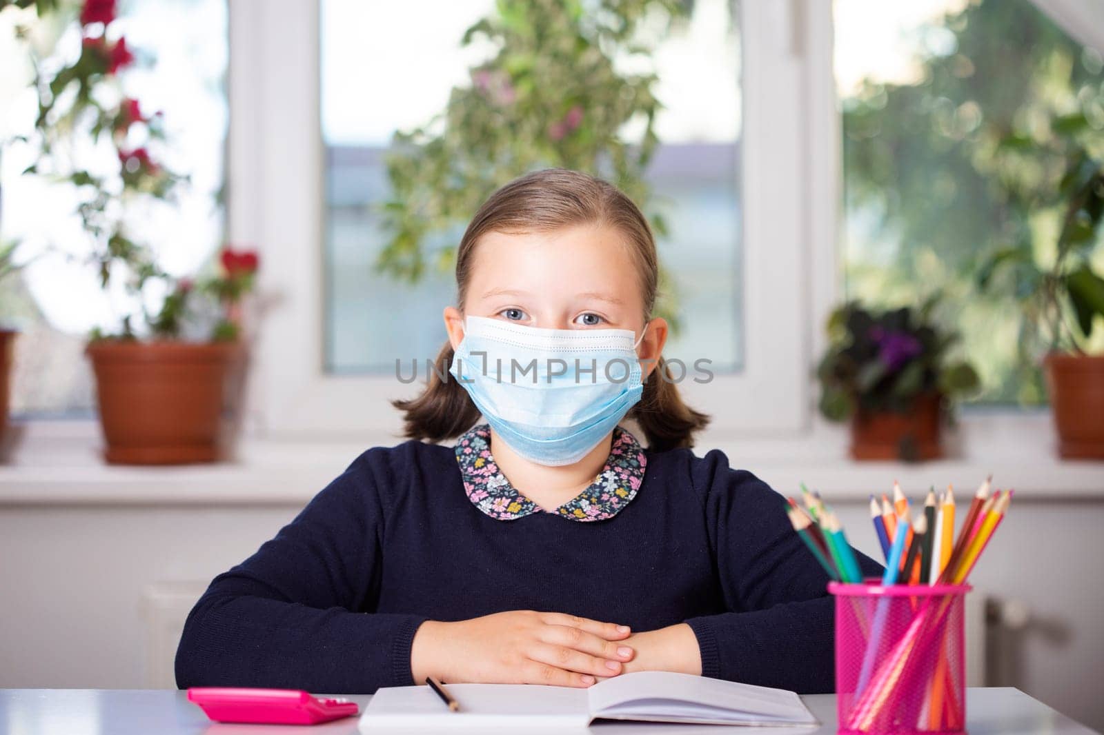 School child wearing mask for protection against coronavirus in school. Measures to prevent the spread of COVID-19 at schools during coronavirus pandemic.