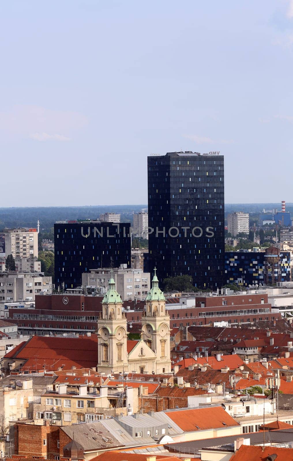 Basilica of the Sacred Heart of Jesus and the new metal and black glass office buildings in the center of the city in the background in Zagreb, Croatia