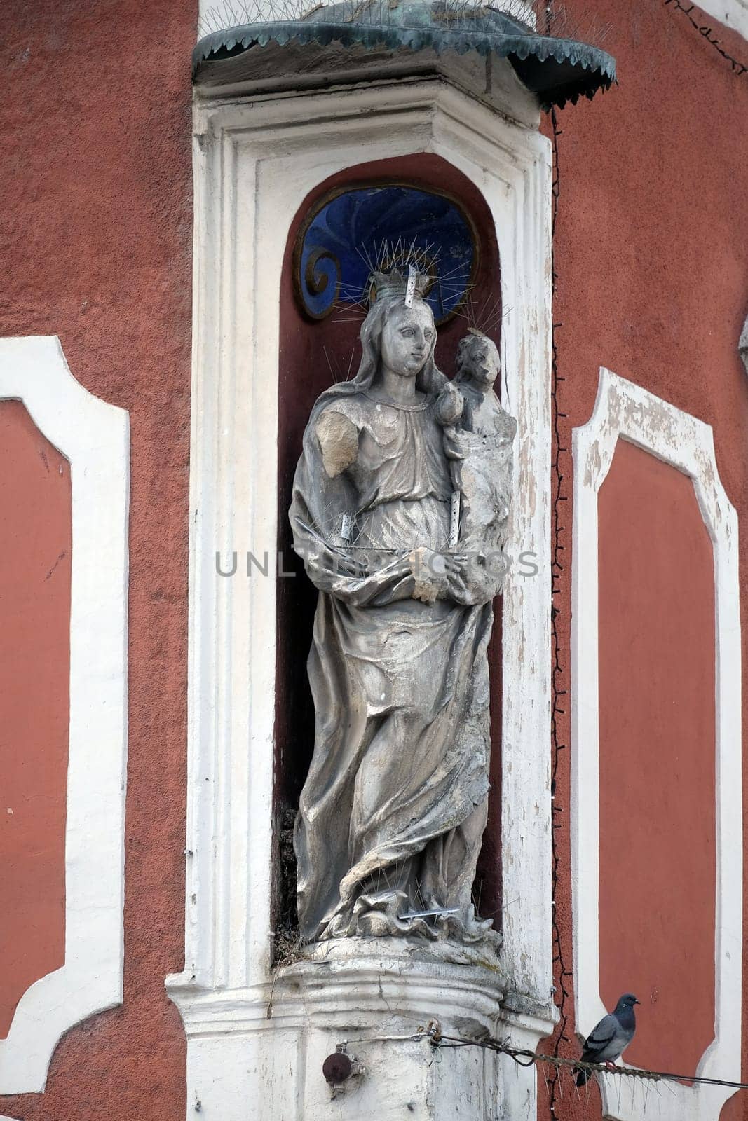 Virgin Mary with baby Jesus, statue on the house facade in Ptuj, town on the Drava River banks, Lower Styria Region, Slovenia