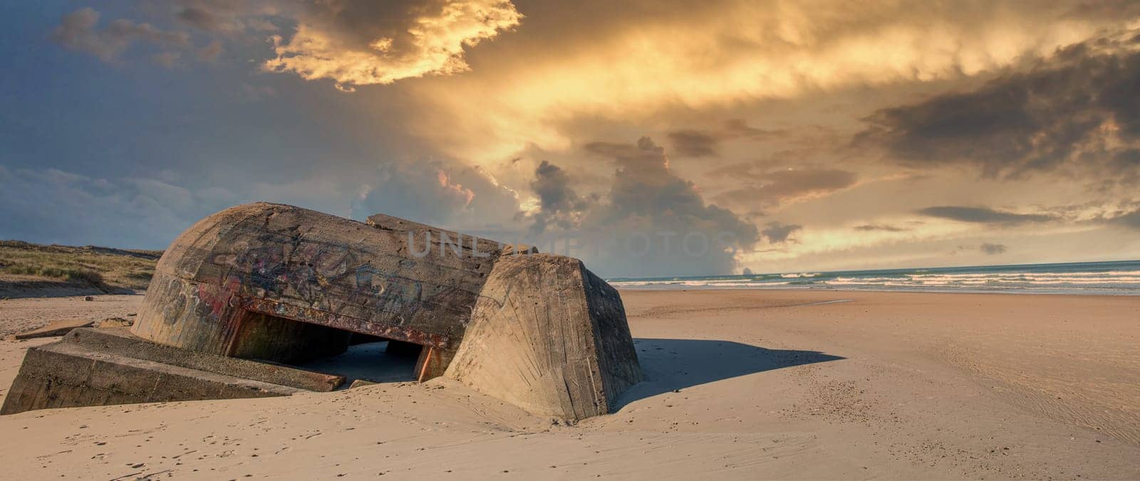 the ruins of german bunker in the beach of Normandy, France