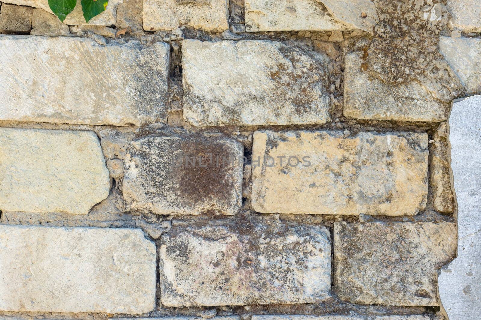 Old block wall with peeling a plaster