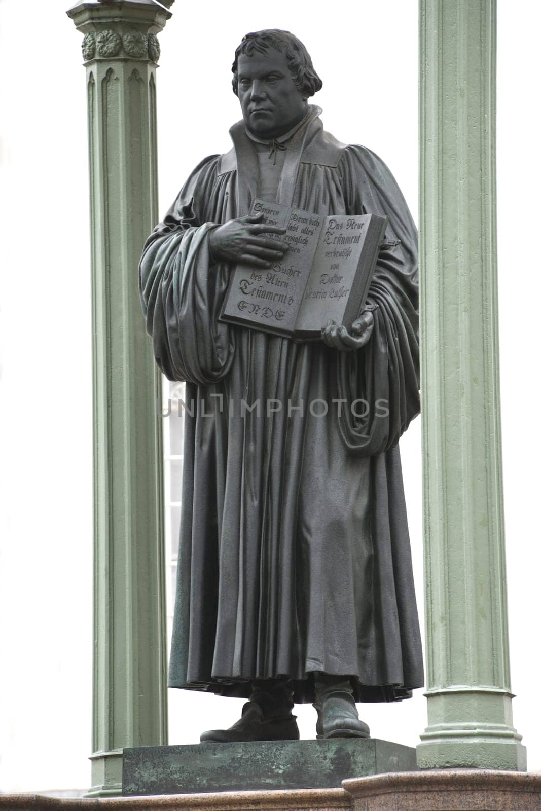 The Martin Luther Monument in Wittenberg . He holds his Bible in his hand. The statue stands on the market square in front of the town hall. Top 10 from Saxony-Anhalt East Germany.
