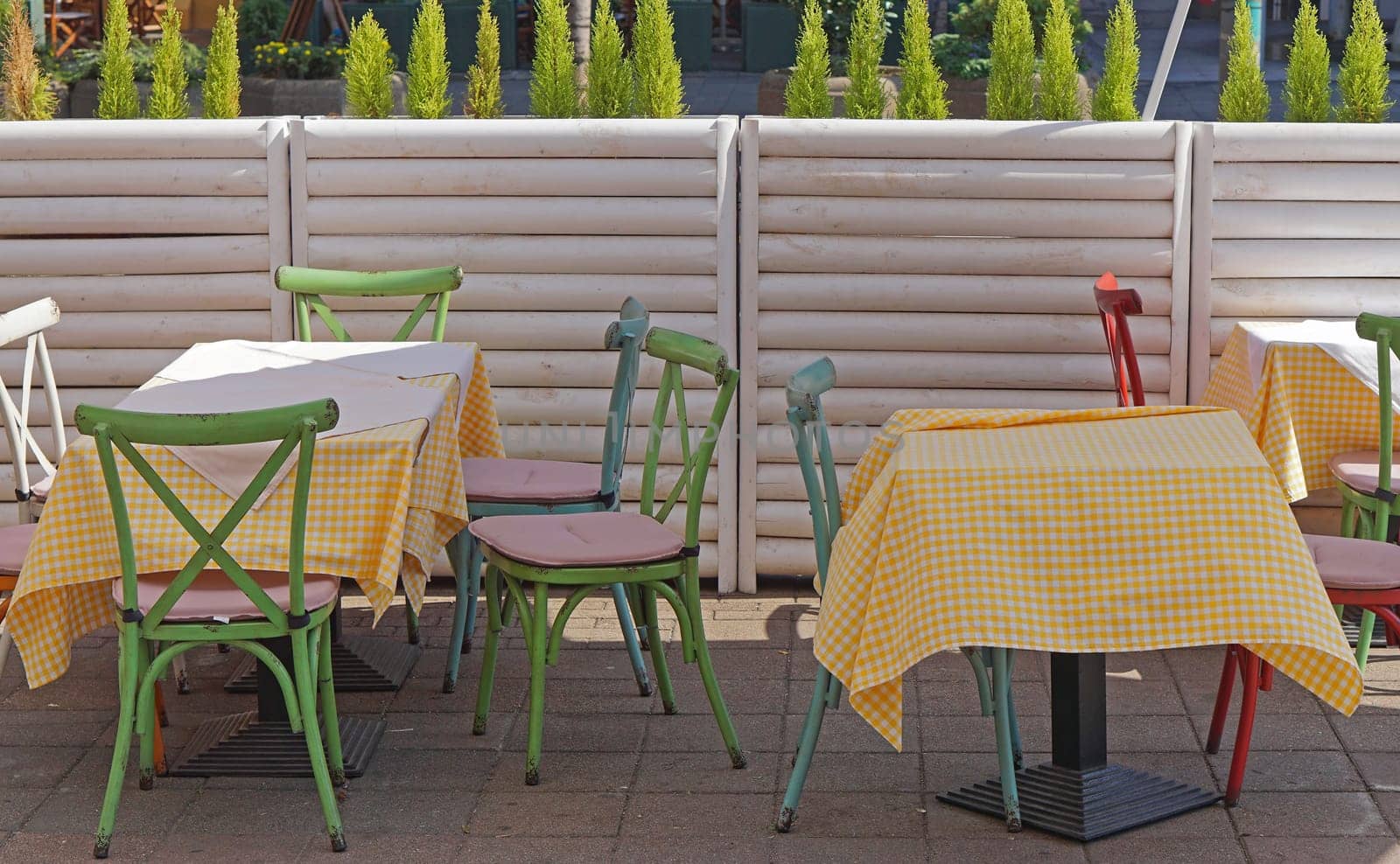 Cafe tables and chairs at city street outdoor
