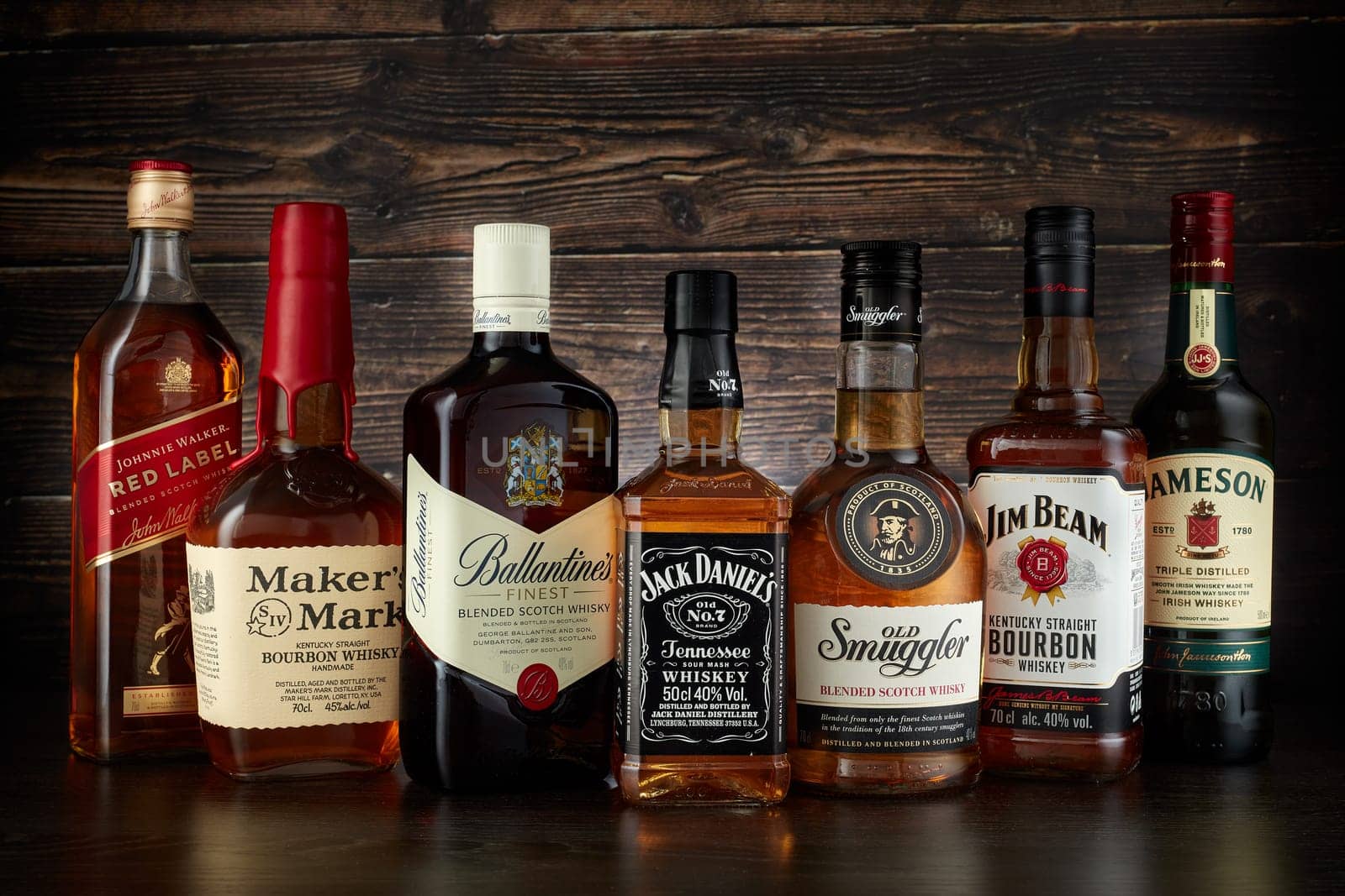 St.Petersburg, Russia - April  2020 - Bottles of several most popular whiskey (whisky) brands on dark wooden background.