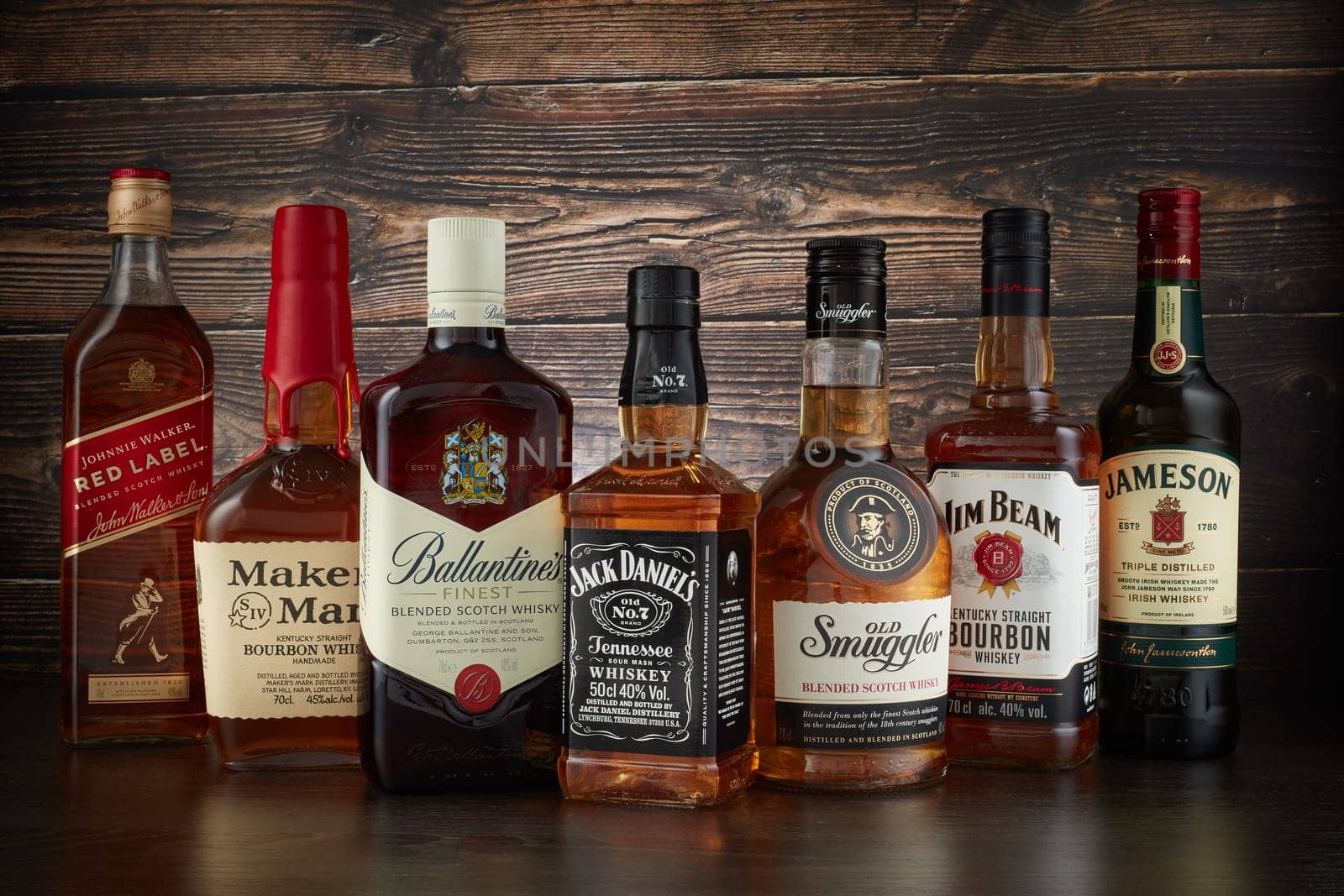 St.Petersburg, Russia - April  2020 - Bottles of several most popular whiskey (whisky) brands on dark wooden background.