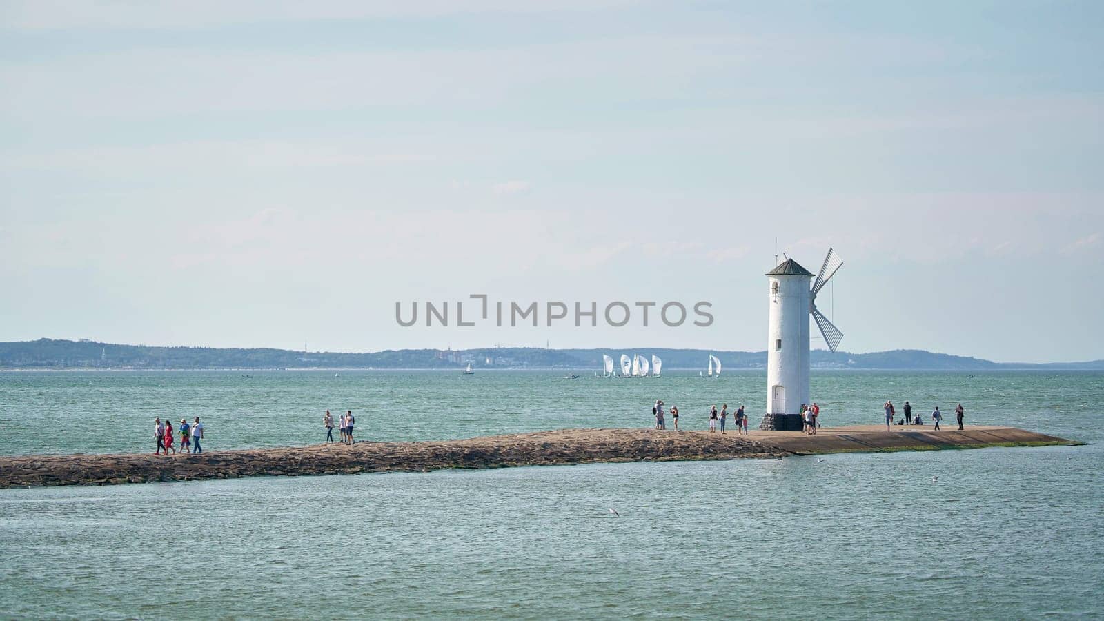 The windmill fire on the shore of the Baltic Sea coast, the symbol of the town of Swinoujscie