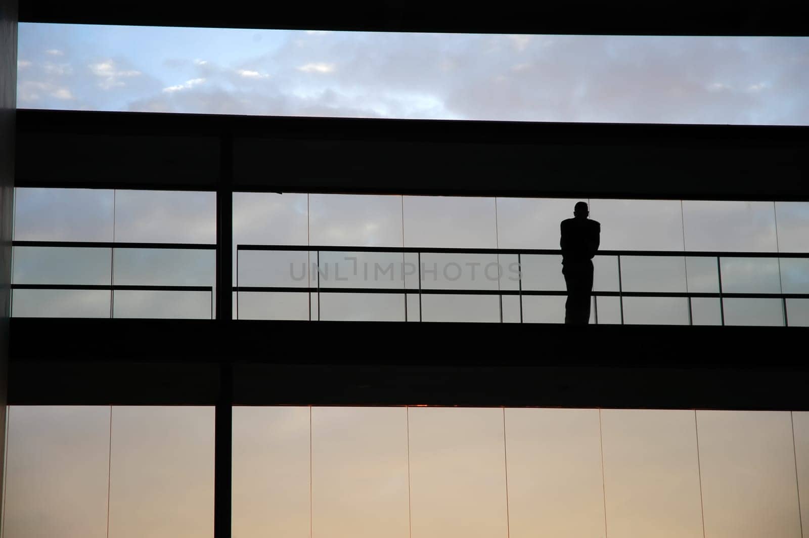 worker inside the building silhouette at sunset