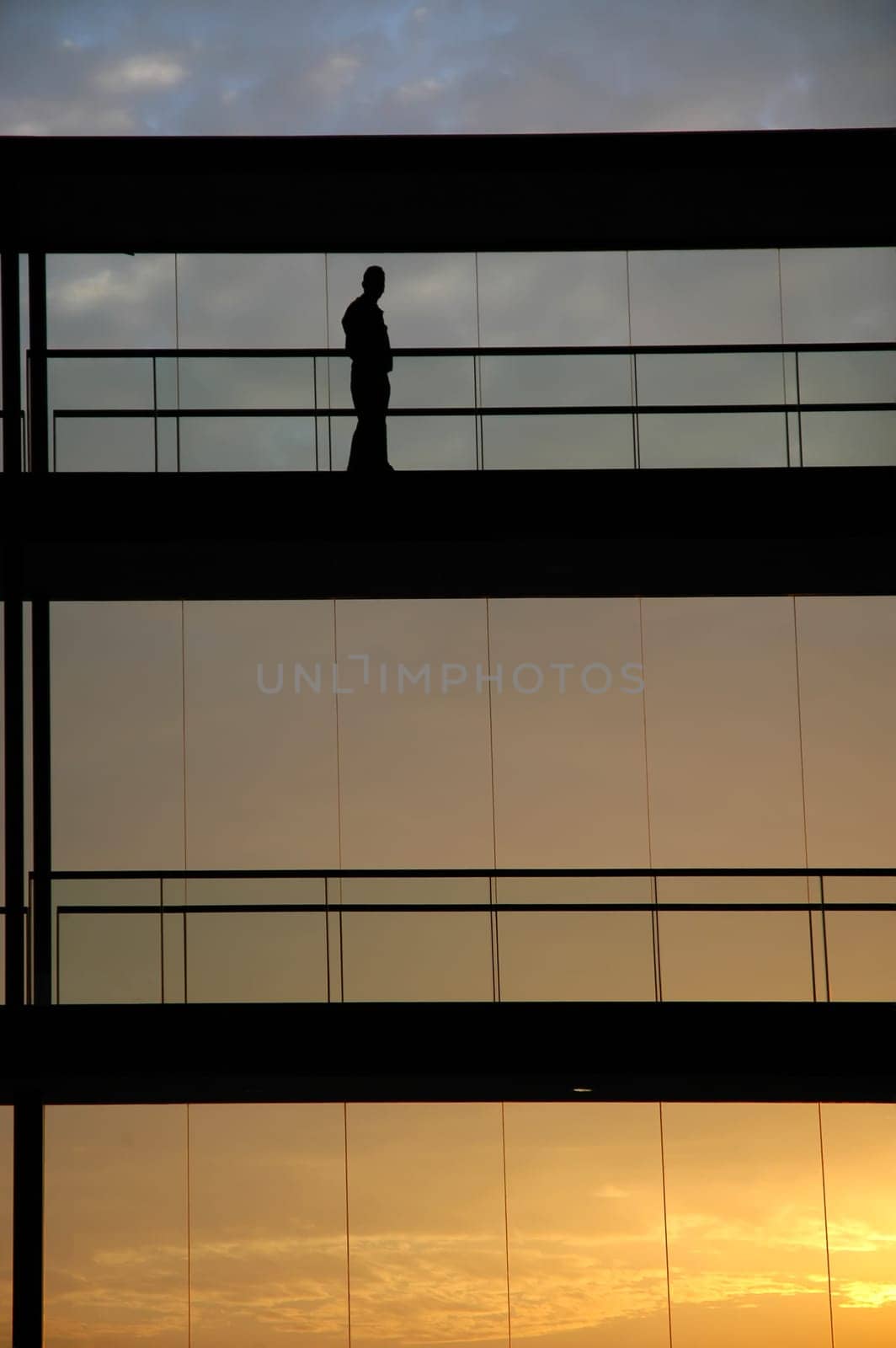 worker inside the building silhouette at sunset