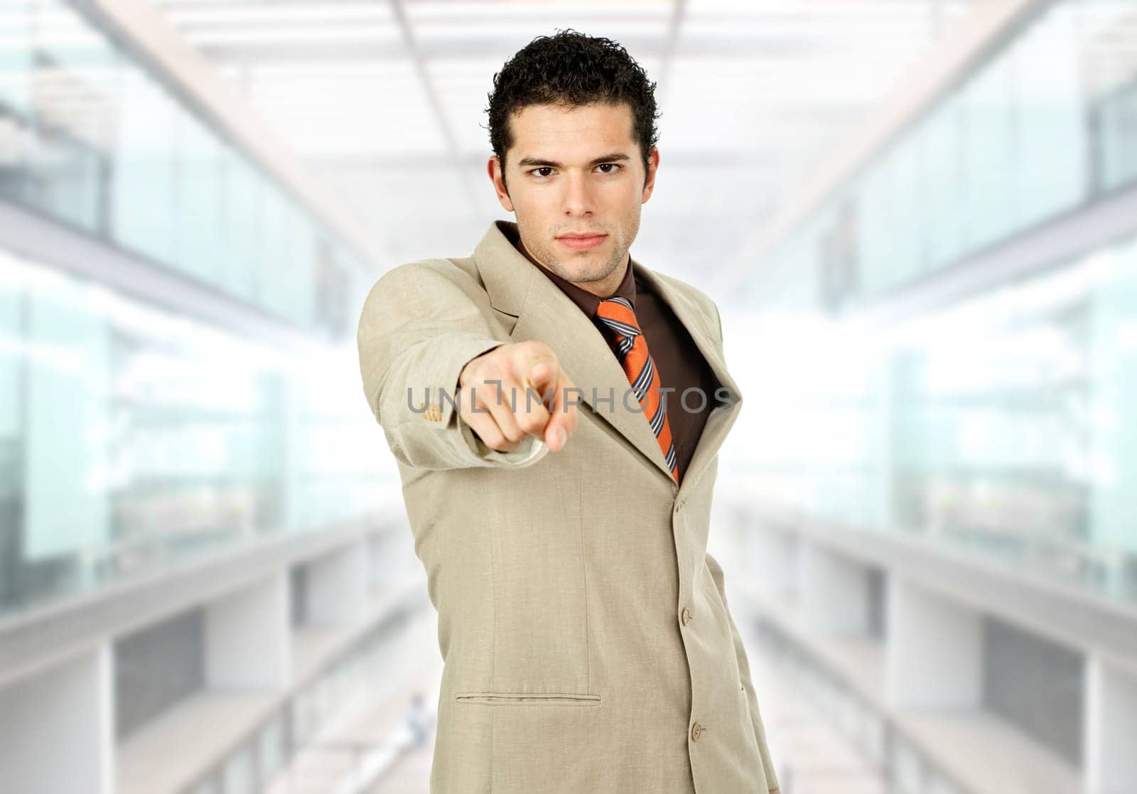 young businessman pointing with his finger at the office