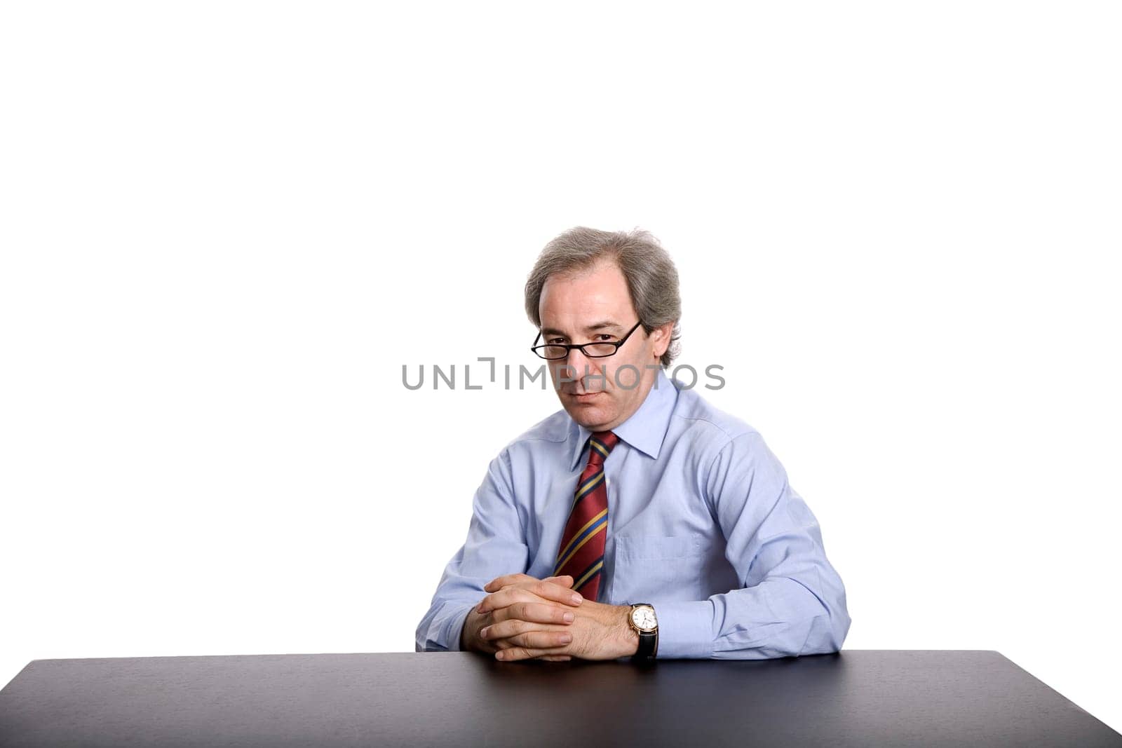mature business man on a desk, isolated on white