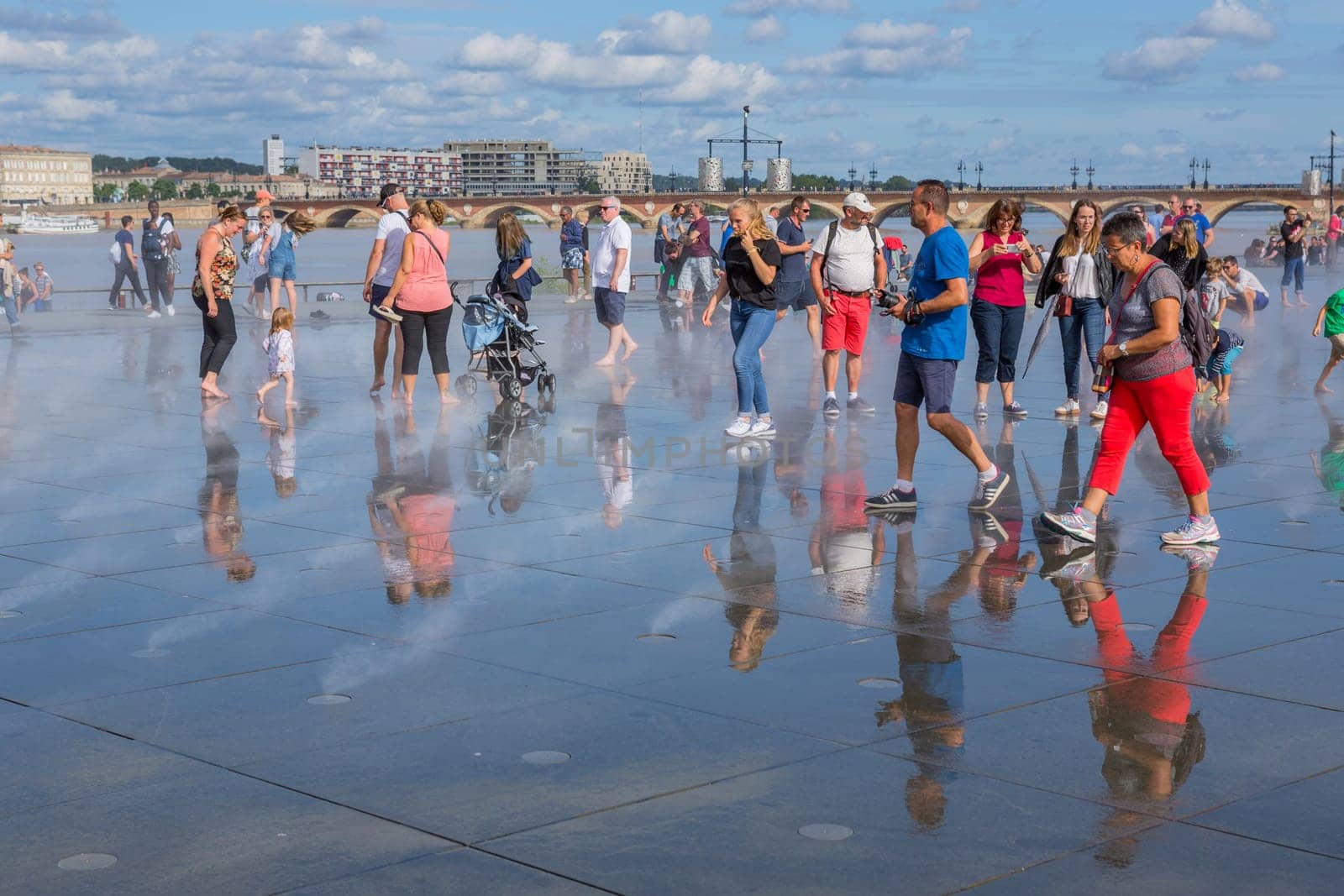 BORDEAUX, FRANCE - AUGUST 11: The Famous Bordeaux water mirror full of people having fun in the water, on August 11, 2019 in Bordeaux, France.