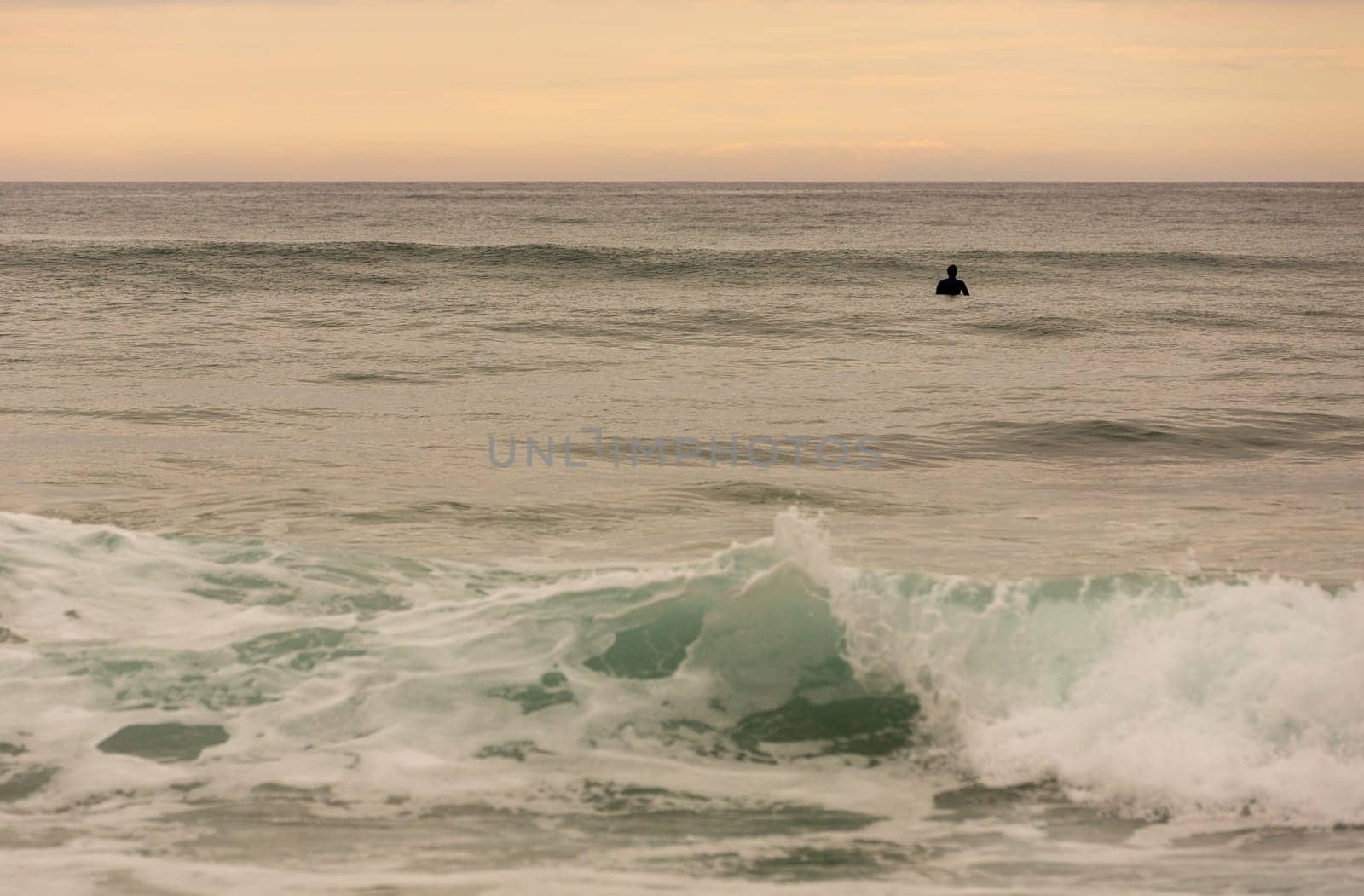 LA VEGA, ASTURIAS, SPAIN. 31 MAY, 2017: Surfers on the beach of La Vega, at dusk, near Llanes, Asturias, Spain